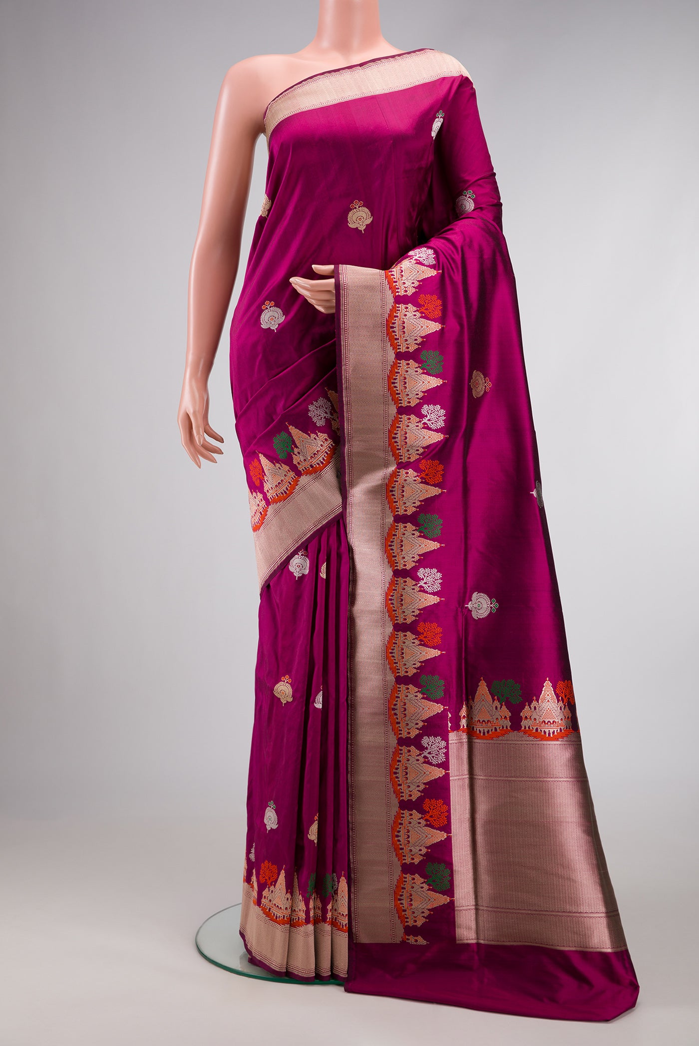 Magenta Dual Tone Banarasi Silk Saree with Zari And Thread Butta on the body and Fancy Border.  displayed on a mannequin