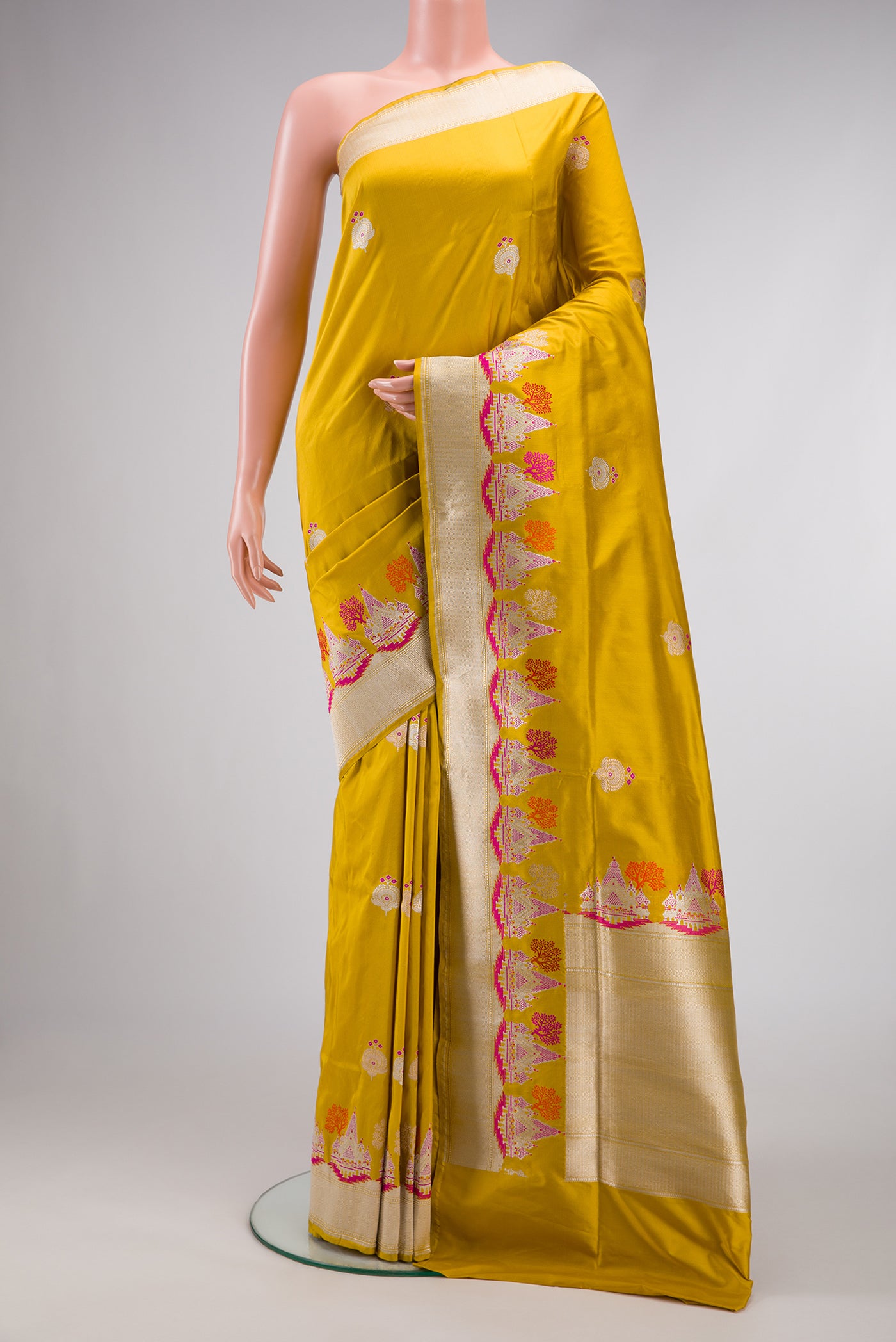 Mustard Dual Tone Banarasi Silk Saree with Zari And Thread Butta on the body and Fancy Border.  displayed on a mannequin