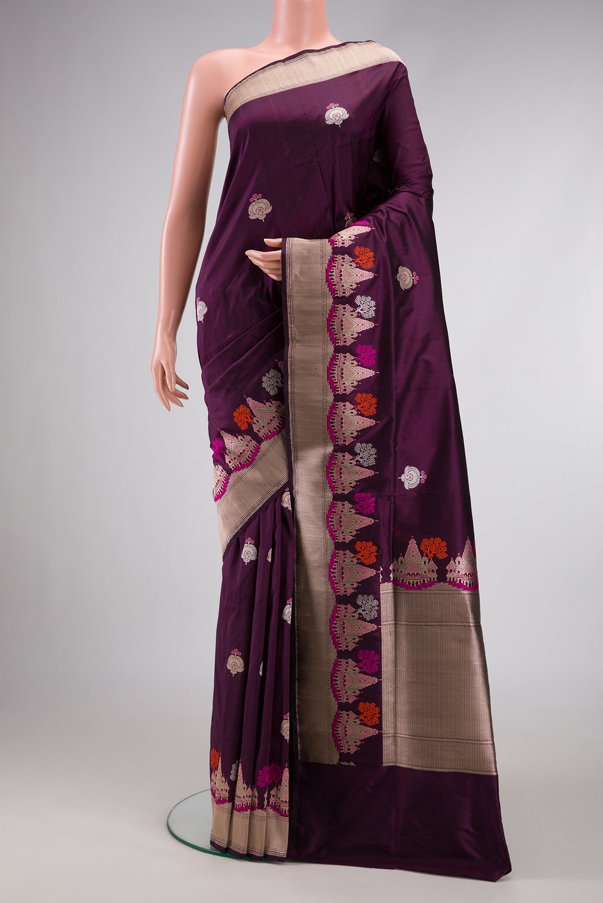 Burgundy Dual Tone Banarasi Silk Saree with Zari And Thread Butta on the body and Fancy Border.  displayed on a mannequin