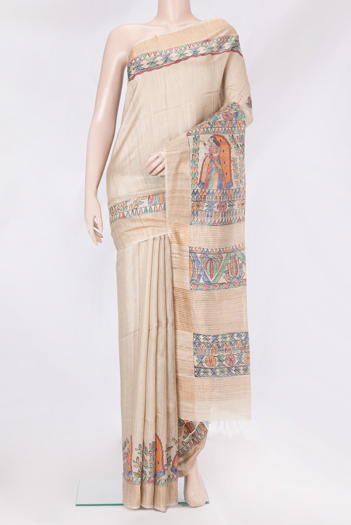 Beige Tussar Silk Saree with Printed design on the body and Fancy Border.  displayed on a mannequin