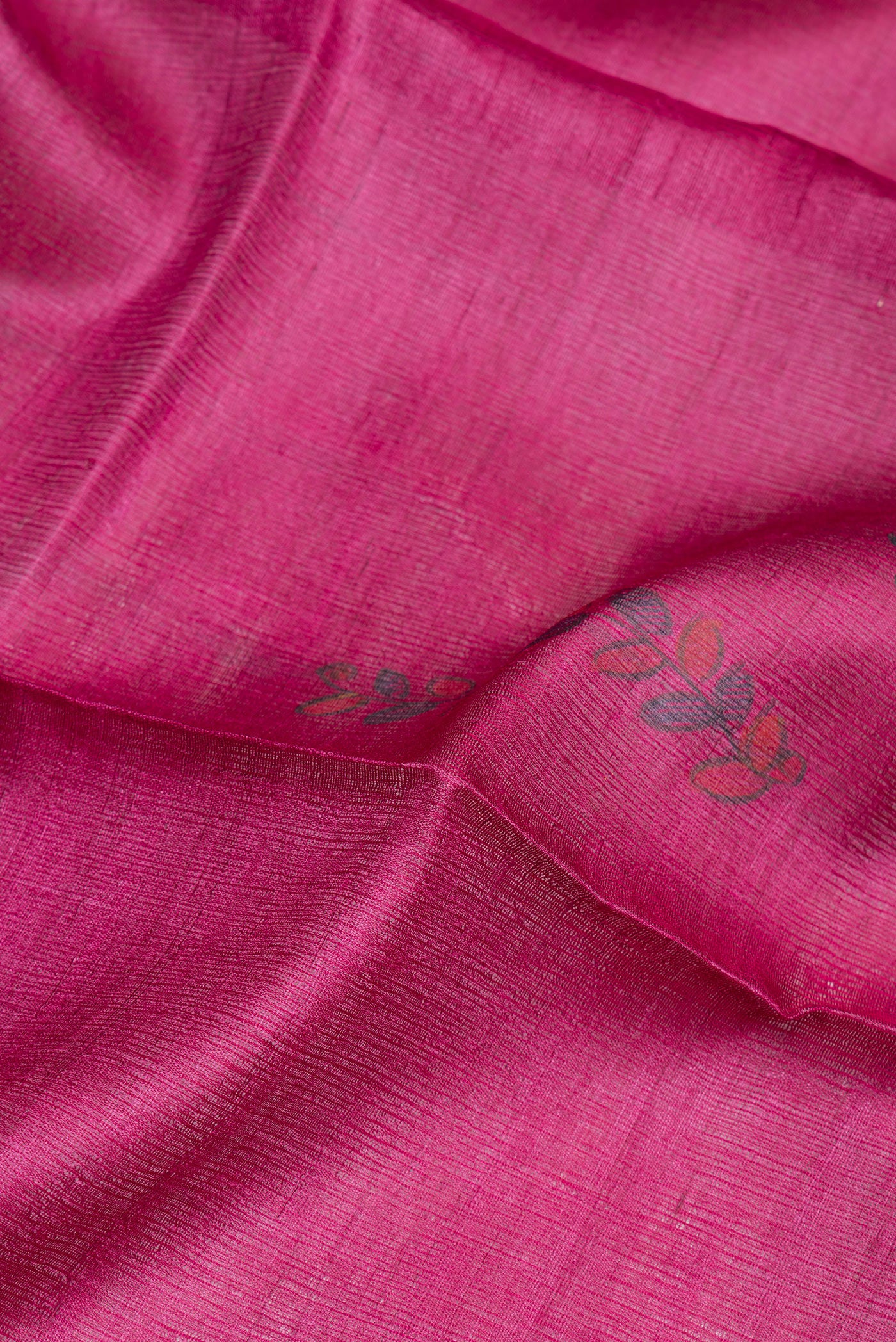 Close up of Magenta Tussar Silk Saree with Printed design on the body and Fancy Border.  displaying folds