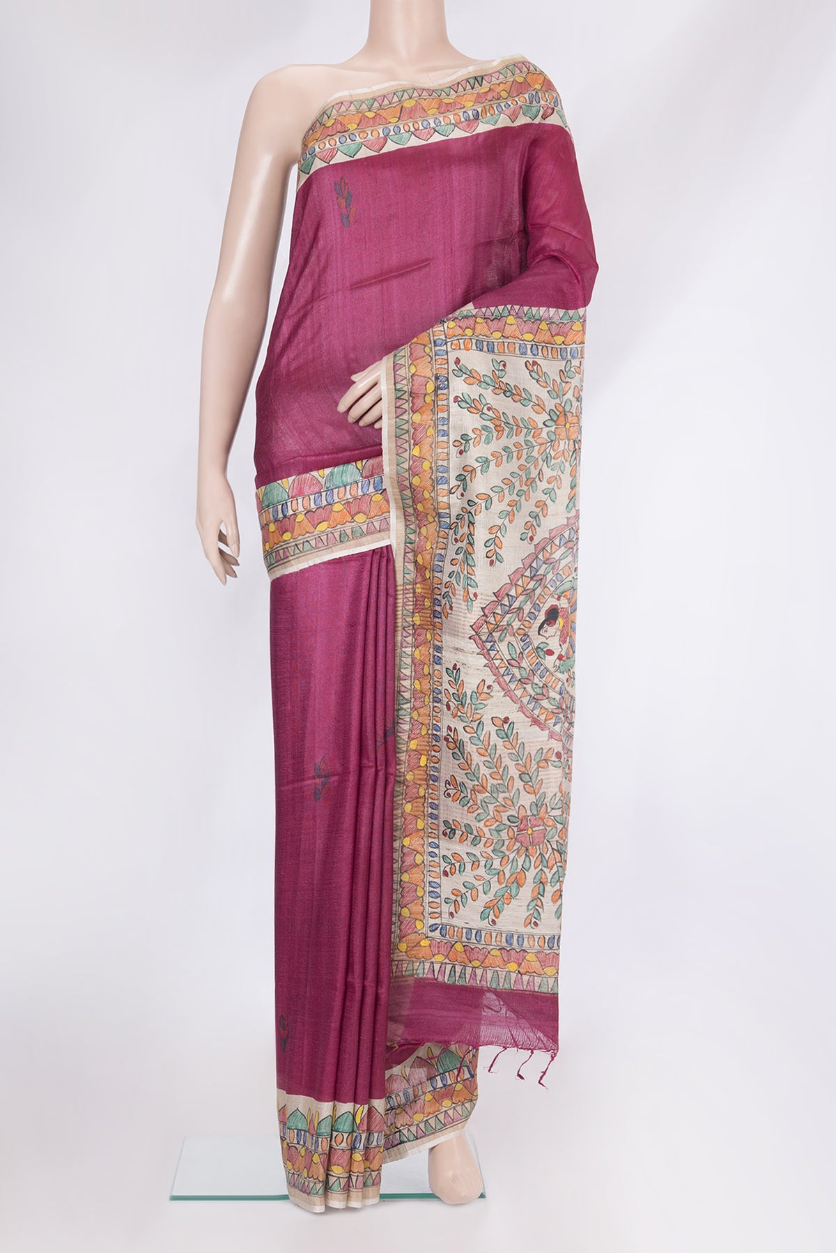 Magenta Tussar Silk Saree with Printed design on the body and Fancy Border.  displayed on a mannequin