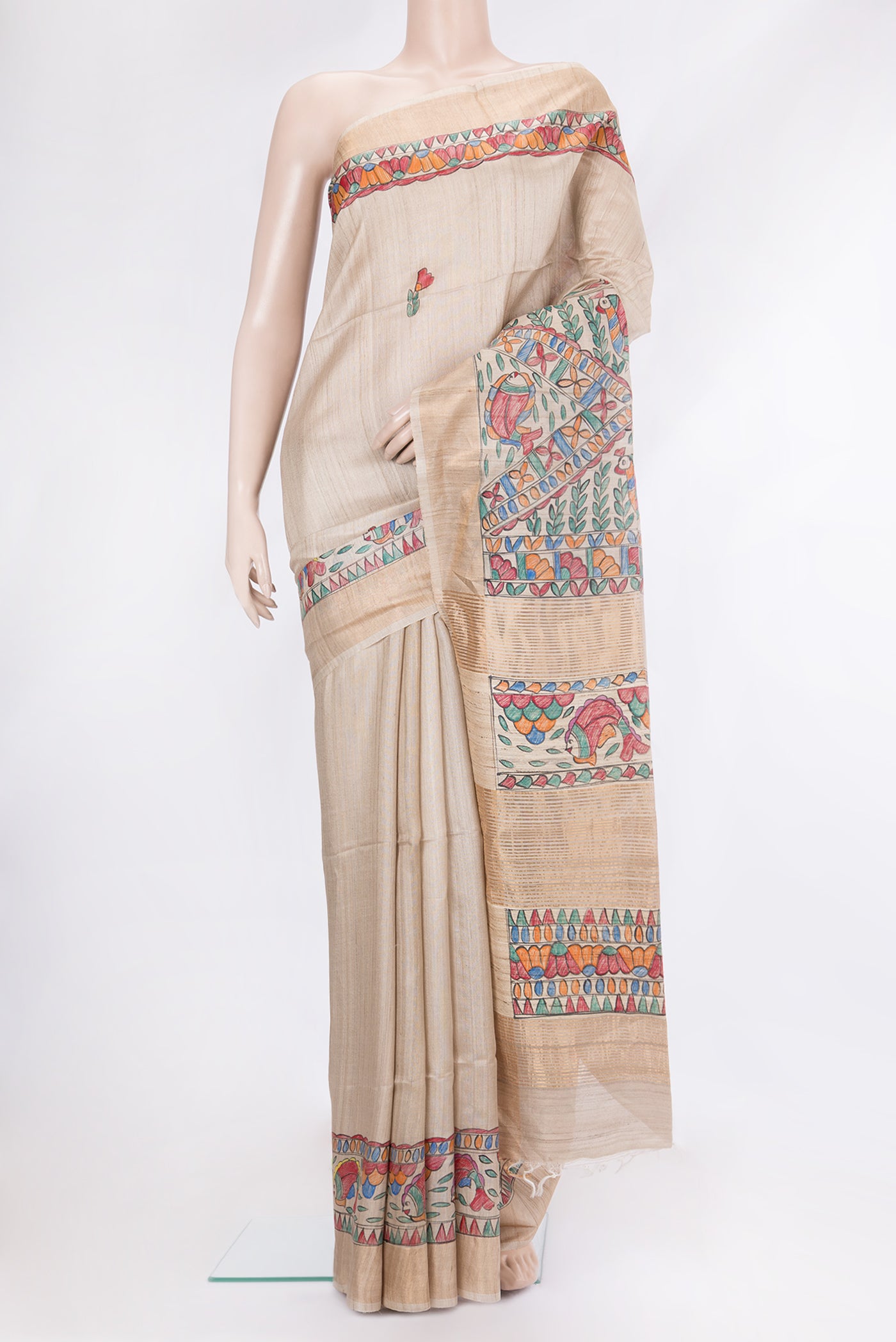 Beige Tussar Silk Saree with Printed design on the body and Fancy Border.  displayed on a mannequin