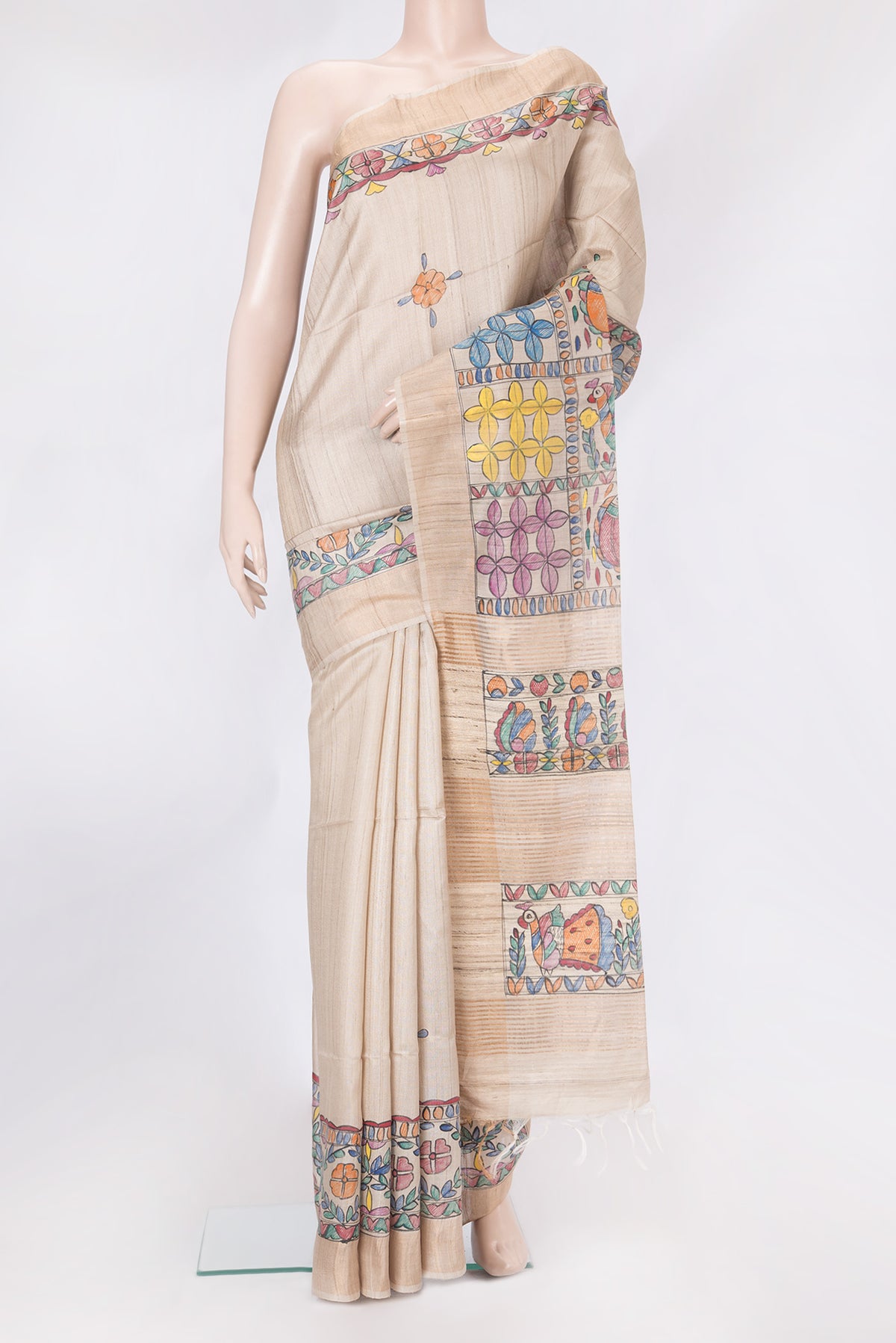Cream Tussar Silk Saree with Printed design on the body and Fancy Border.  displayed on a mannequin
