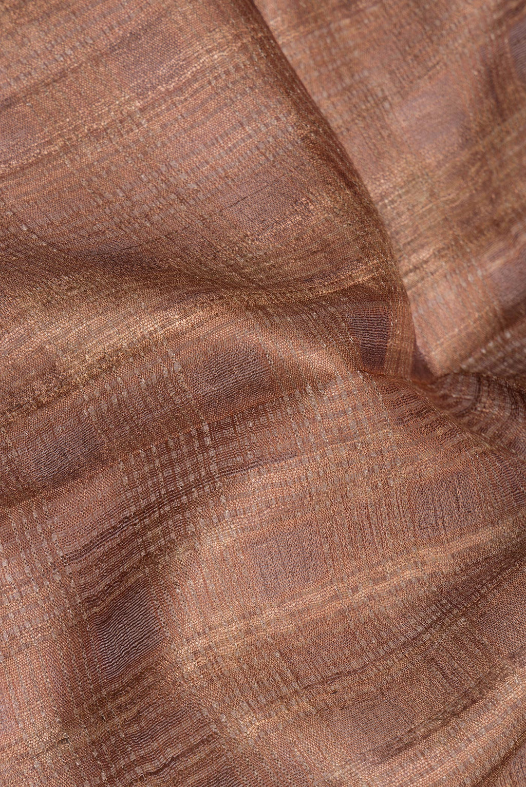 Close up of Pure Silk Brown Tussar Saree with Plain Body and Fancy Border.  displaying folds