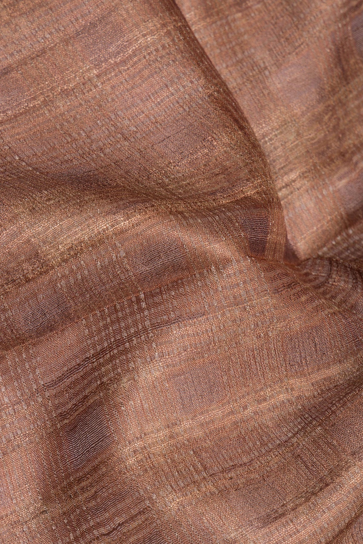 Close up of Pure Silk Brown Tussar Saree with Plain Body and Fancy Border.  displaying folds