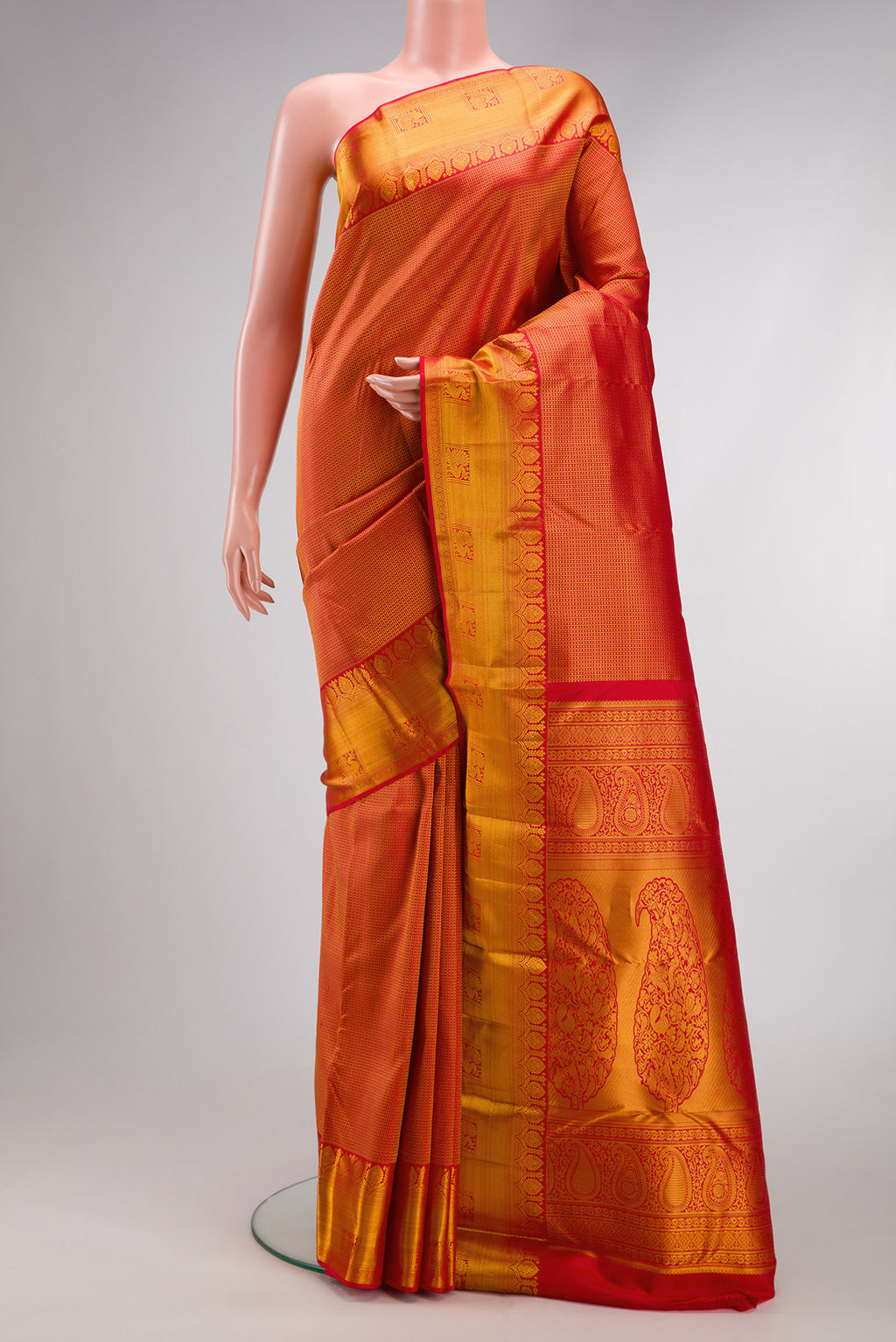 Red Kanjivaram Silk Saree with Zari Brocade on the body and Zari Border.  displayed on a mannequin