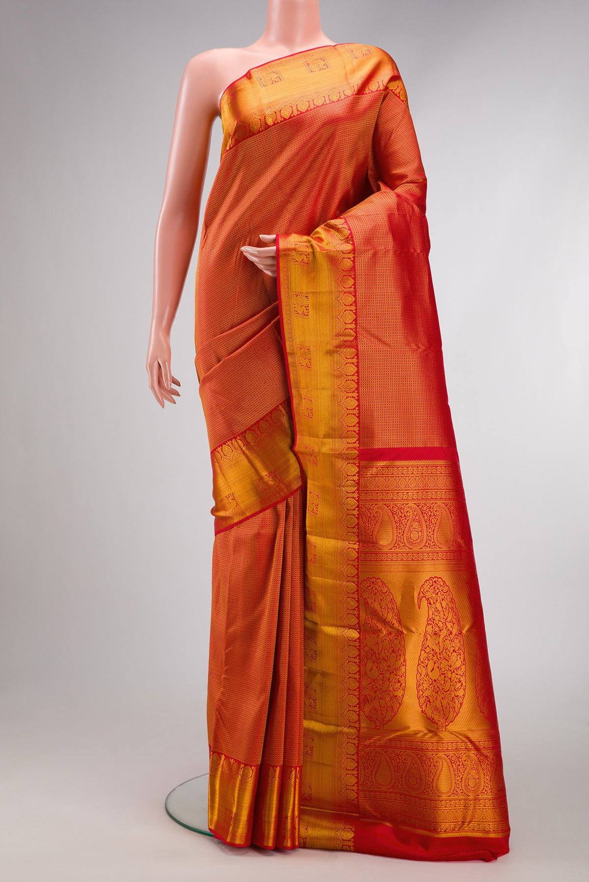 Red Kanjivaram Silk Saree with Zari Brocade on the body and Zari Border.  displayed on a mannequin