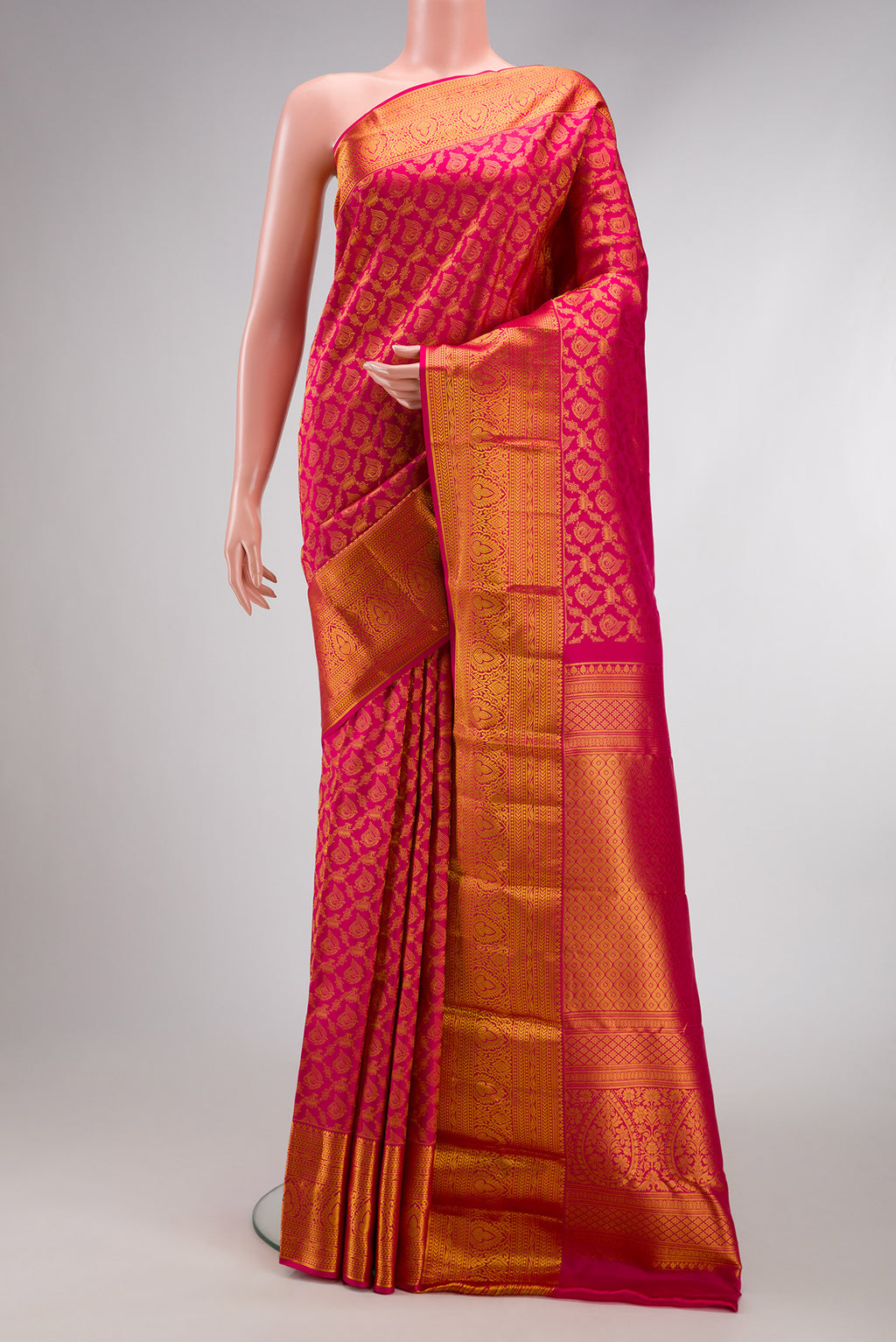 Dark Pink Kanjivaram Silk Saree with Zari Brocade on the body and Zari Border.  displayed on a mannequin
