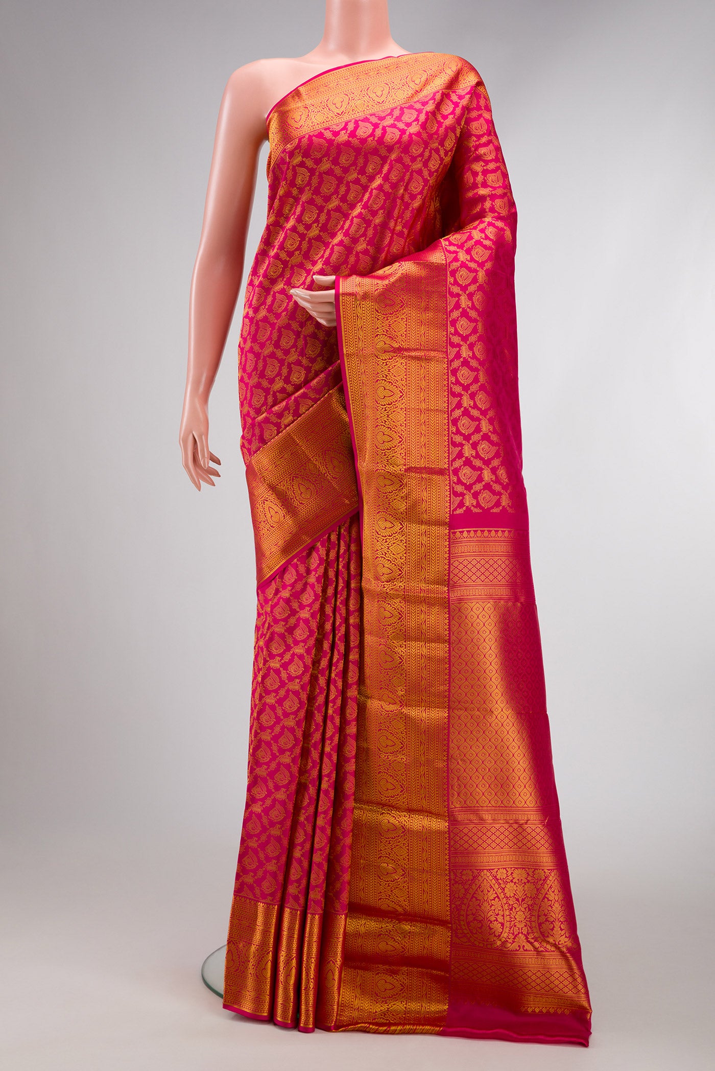 Dark Pink Kanjivaram Silk Saree with Zari Brocade on the body and Zari Border.  displayed on a mannequin