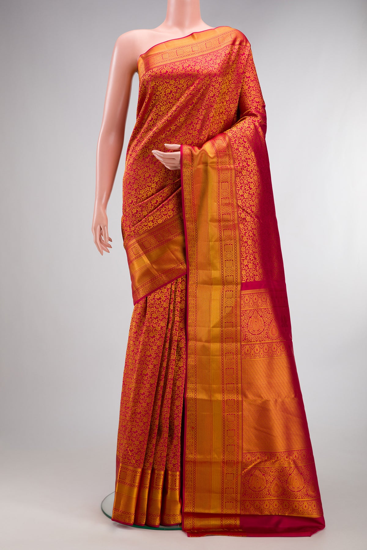 Pure Silk Red Kanjivaram Saree with Zari Brocade on the body and Zari Border.  displayed on a mannequin