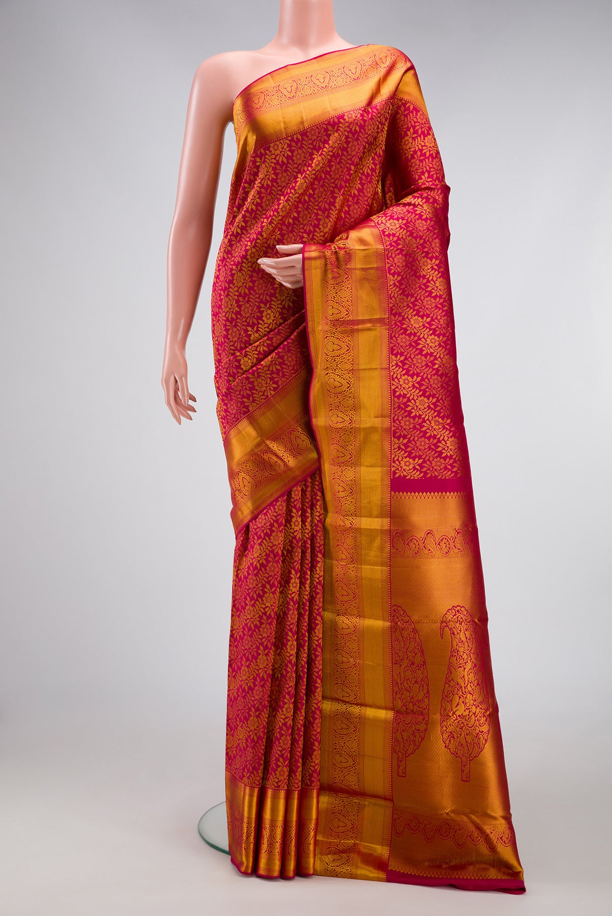 Dark Pink Kanjivaram Silk Saree with Zari Brocade on the body and Zari Border.  displayed on a mannequin