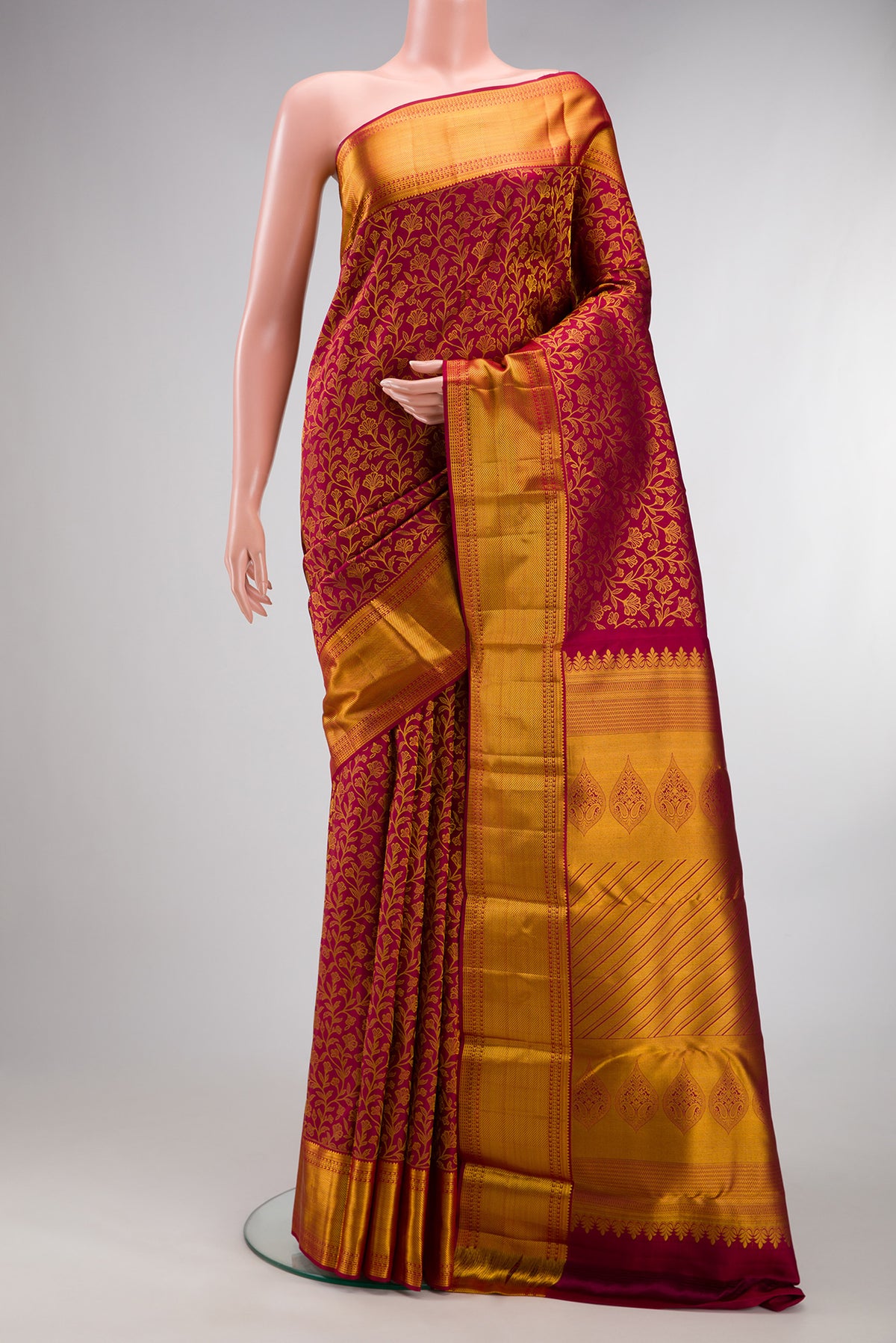 Pure Silk Maroon Kanjivaram Saree with Zari Brocade on the body and Zari Border.  displayed on a mannequin