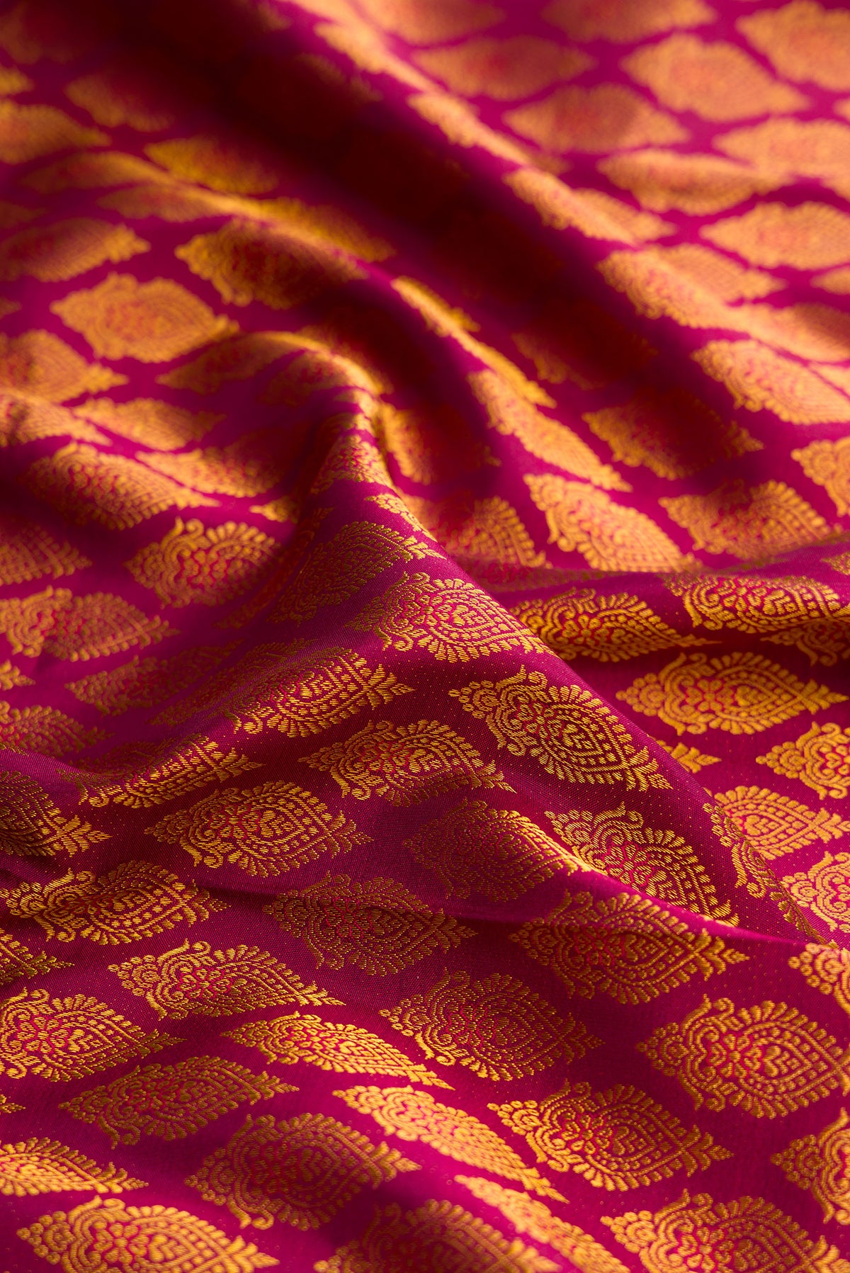 Close up of Pure Silk Maroon Kanjivaram Saree with Zari Brocade on the body and Zari Border.  displaying folds
