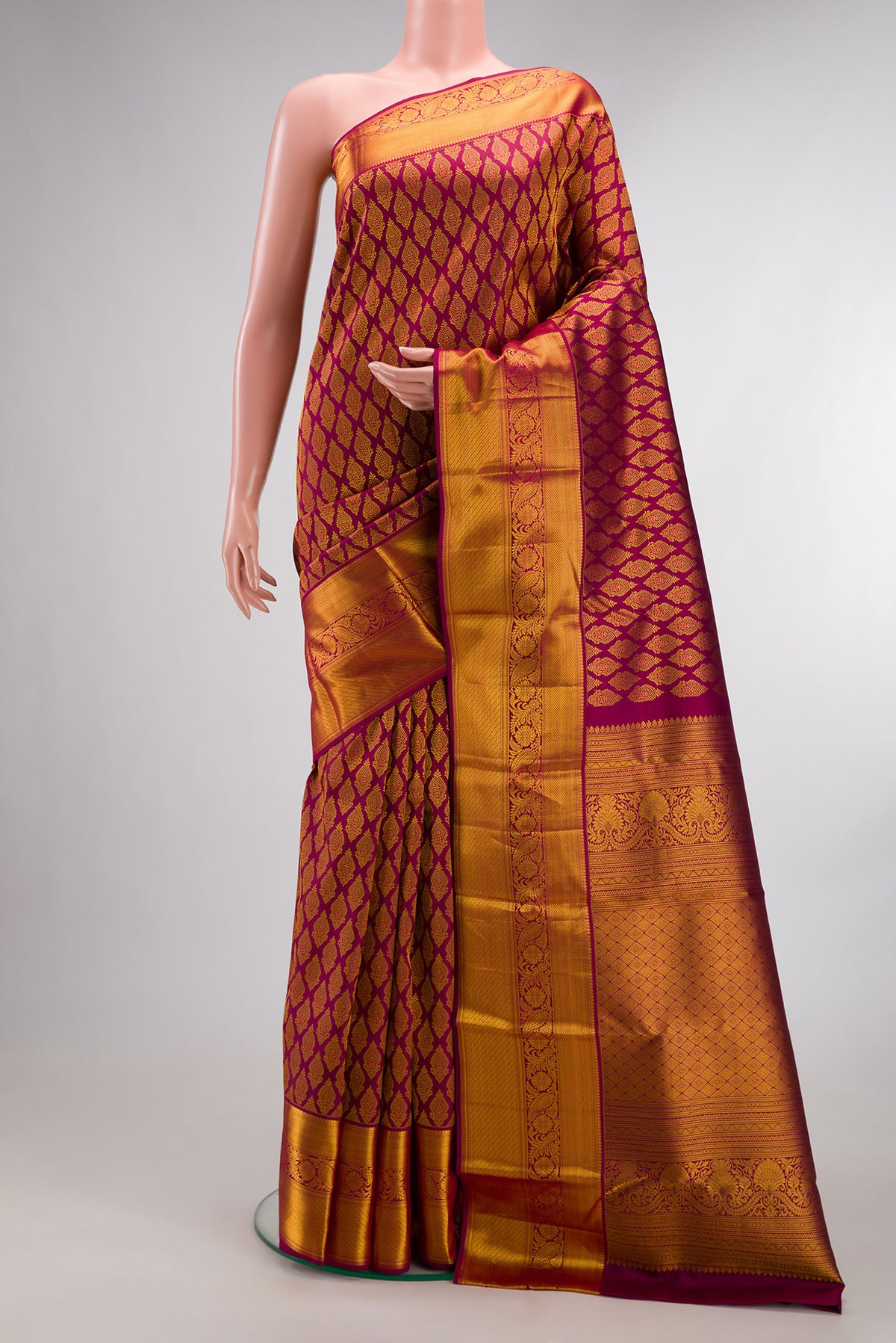 Pure Silk Maroon Kanjivaram Saree with Zari Brocade on the body and Zari Border.  displayed on a mannequin