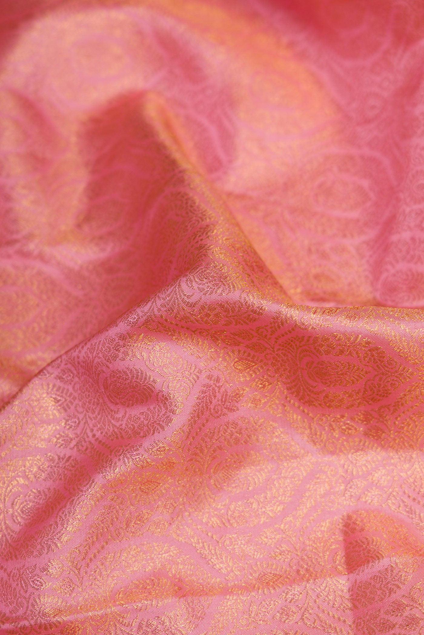 Close up of Pink Dual Tone Kanjivaram Silk Saree with Zari Brocade on the body and Fancy Border.  displaying folds