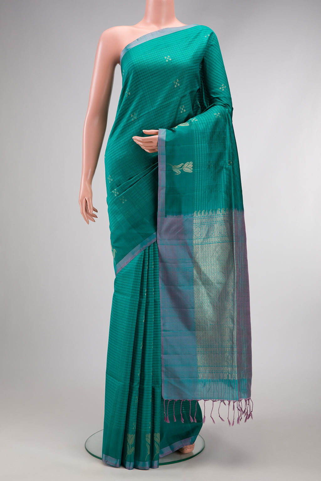 Peacock Blue Soft Silk Saree with Checked design on the body and Plain Border.  displayed on a mannequin