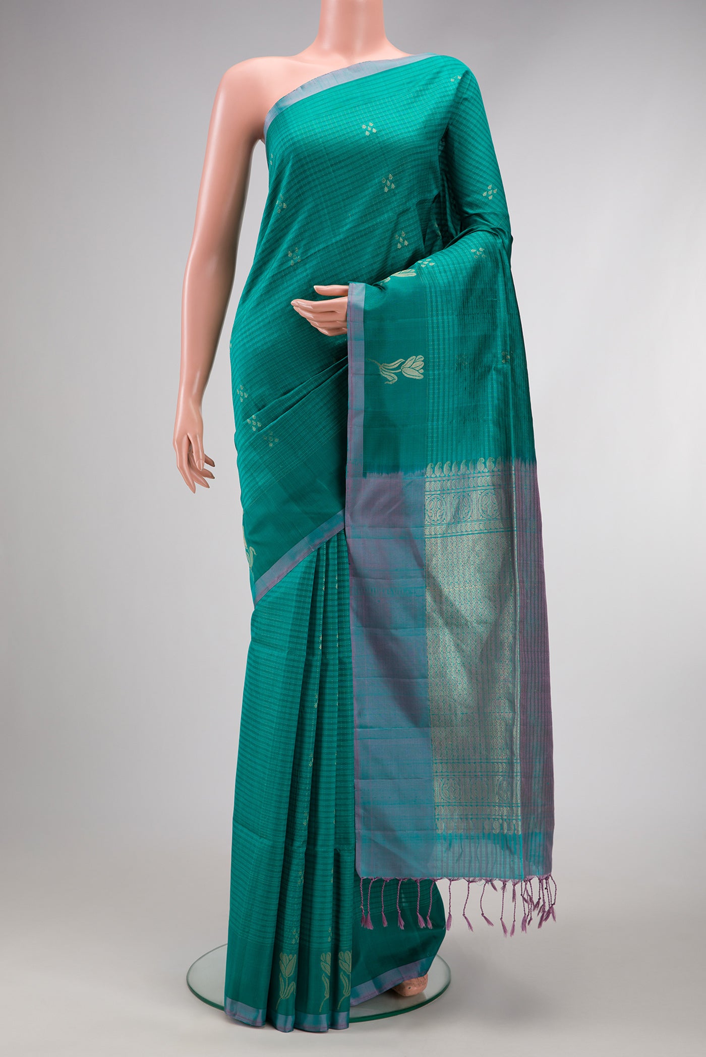 Peacock Blue Soft Silk Saree with Checked design on the body and Plain Border.  displayed on a mannequin