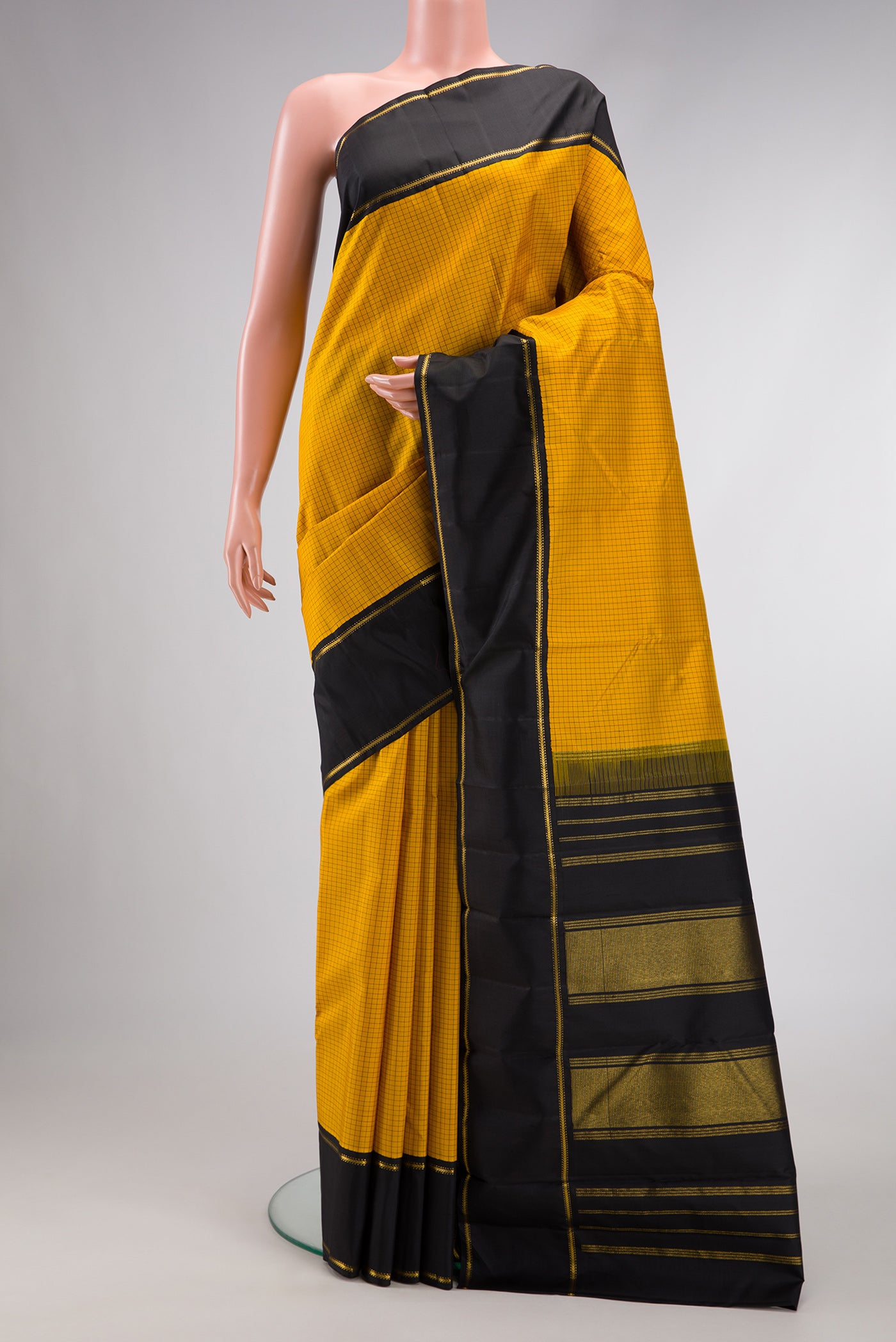 Pure Silk Pure Zari Yellow Dual Tone Kanjivaram Saree with Checked design on the body and Zari And Thread Border.  displayed on a mannequin