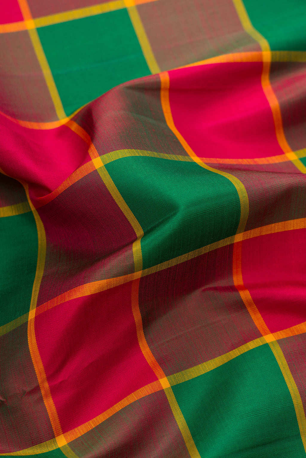 Close up of Green, Maroon & Burgundy Color Kanjivaram Silk Saree with Checked design on the body and Plain Border.  displaying folds