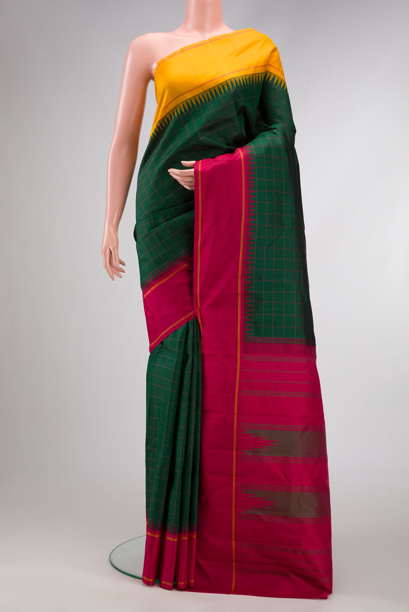 Green, Maroon & Burgundy Dual Tone Kanjivaram Silk Saree with Checked design on the body and Ganga Jamuna Border.  displayed on a mannequin