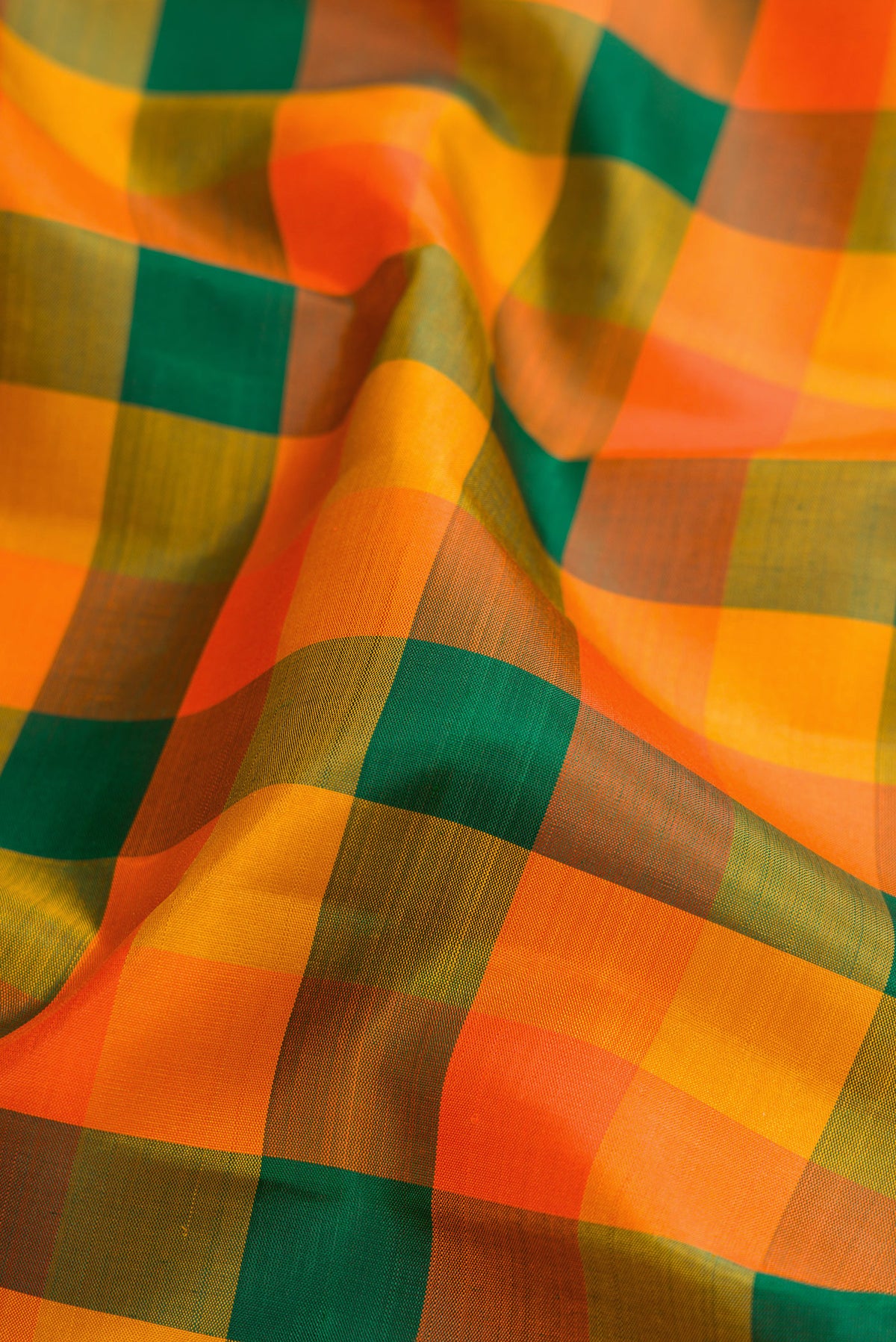 Close up of Multi Color Kanjivaram Silk Saree with Checked design on the body and Zari Border.  displaying folds