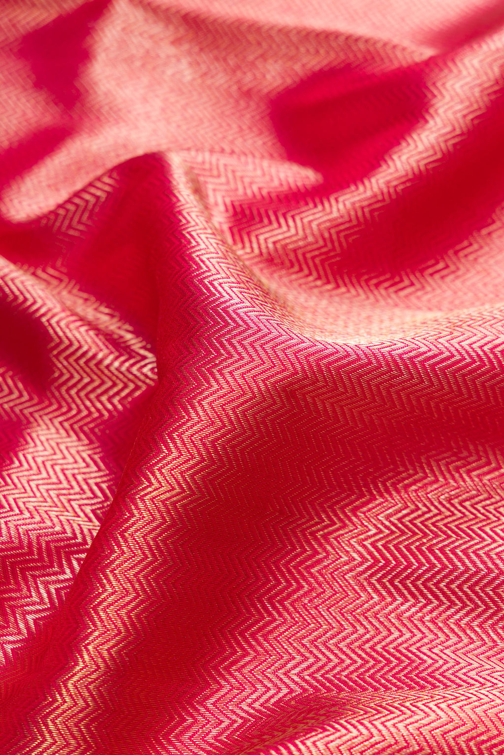 Close up of Pink Dual Tone Kanjivaram Tissue Silk Saree with Zari Brocade on the body and Paithani Border.  displaying folds
