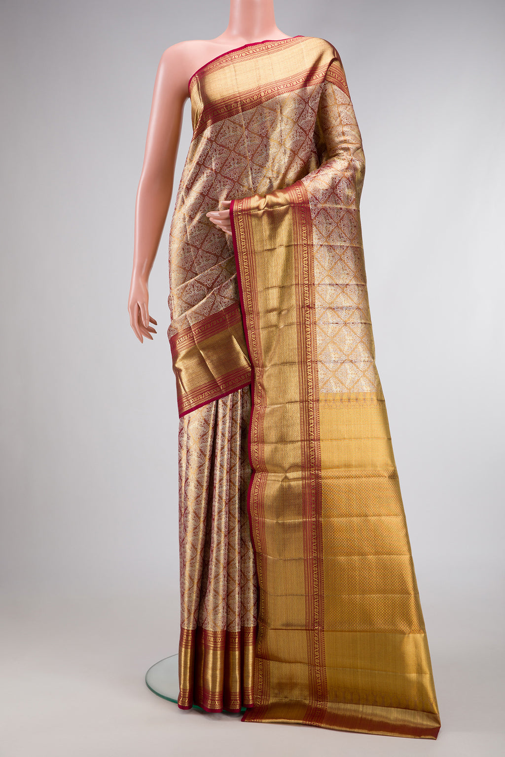 Gold Dual Tone Kanjivaram Tissue Silk Saree with Zari Brocade on the body and Zari Border.  displayed on a mannequin