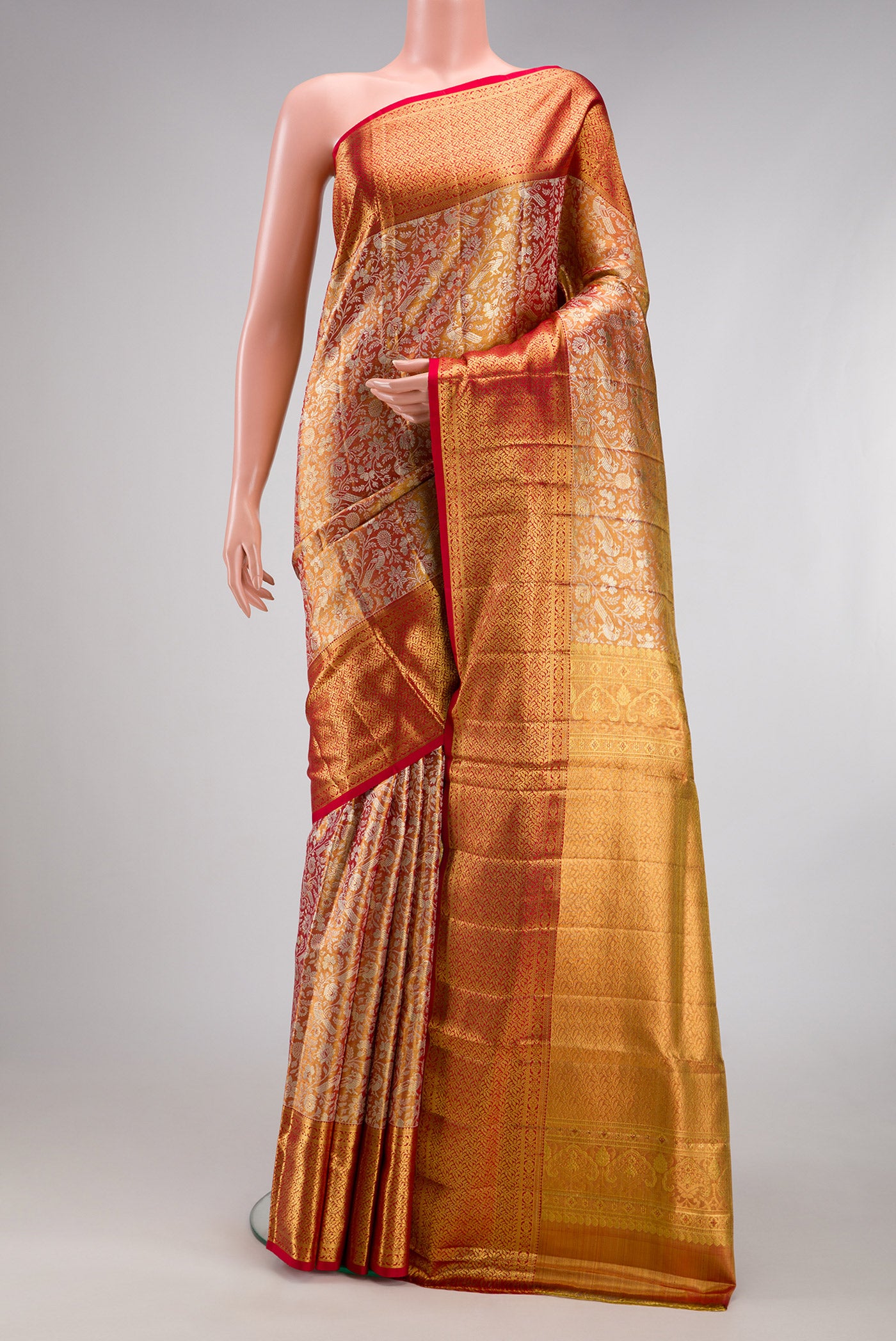 Gold Dual Tone Kanjivaram Tissue Silk Saree with Zari Brocade on the body and Zari Border.  displayed on a mannequin