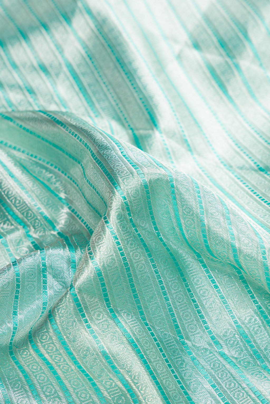 Close up of Pure Silk Pure Zari Sky Blue Dual Tone Kanjivaram Tissue Saree with Zari Brocade on the body and Zari Border.  displaying folds