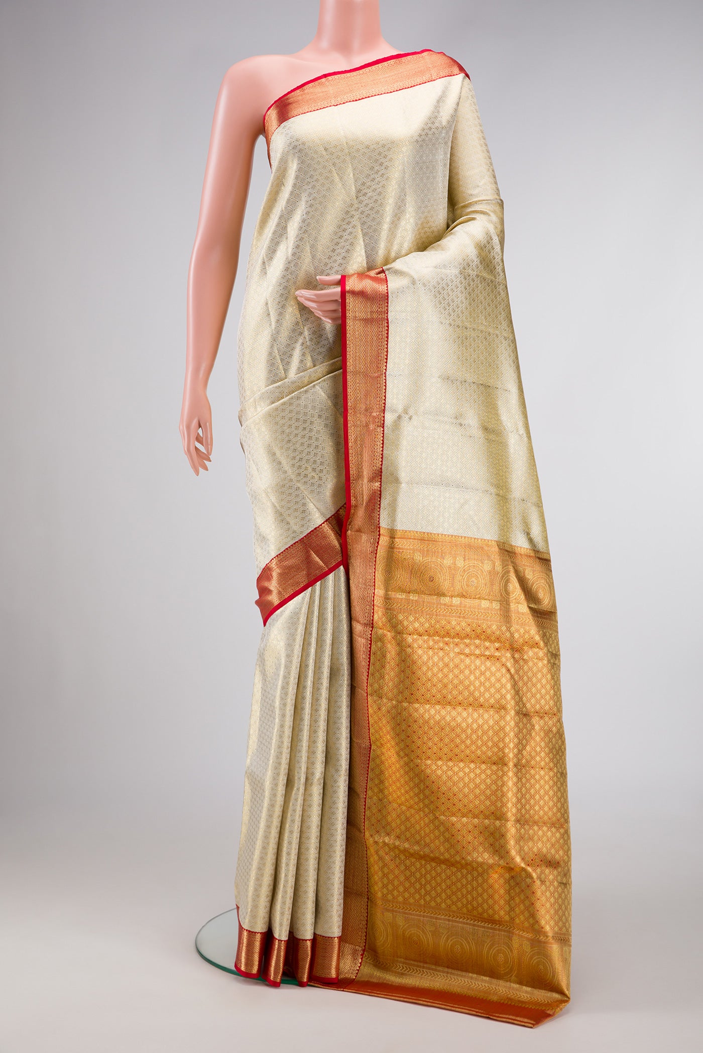 Off White Dual Tone Kanjivaram Tissue Silk Saree with Zari Brocade on the body and Zari Border.  displayed on a mannequin