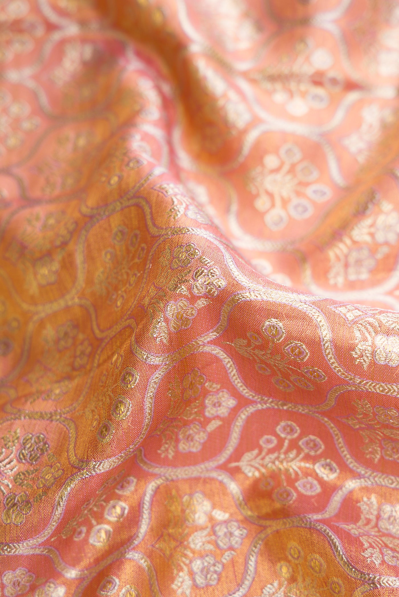 Close up of Pink Dual Tone Kanjivaram Tissue Silk Saree with Zari Brocade on the body and Zari Border.  displaying folds