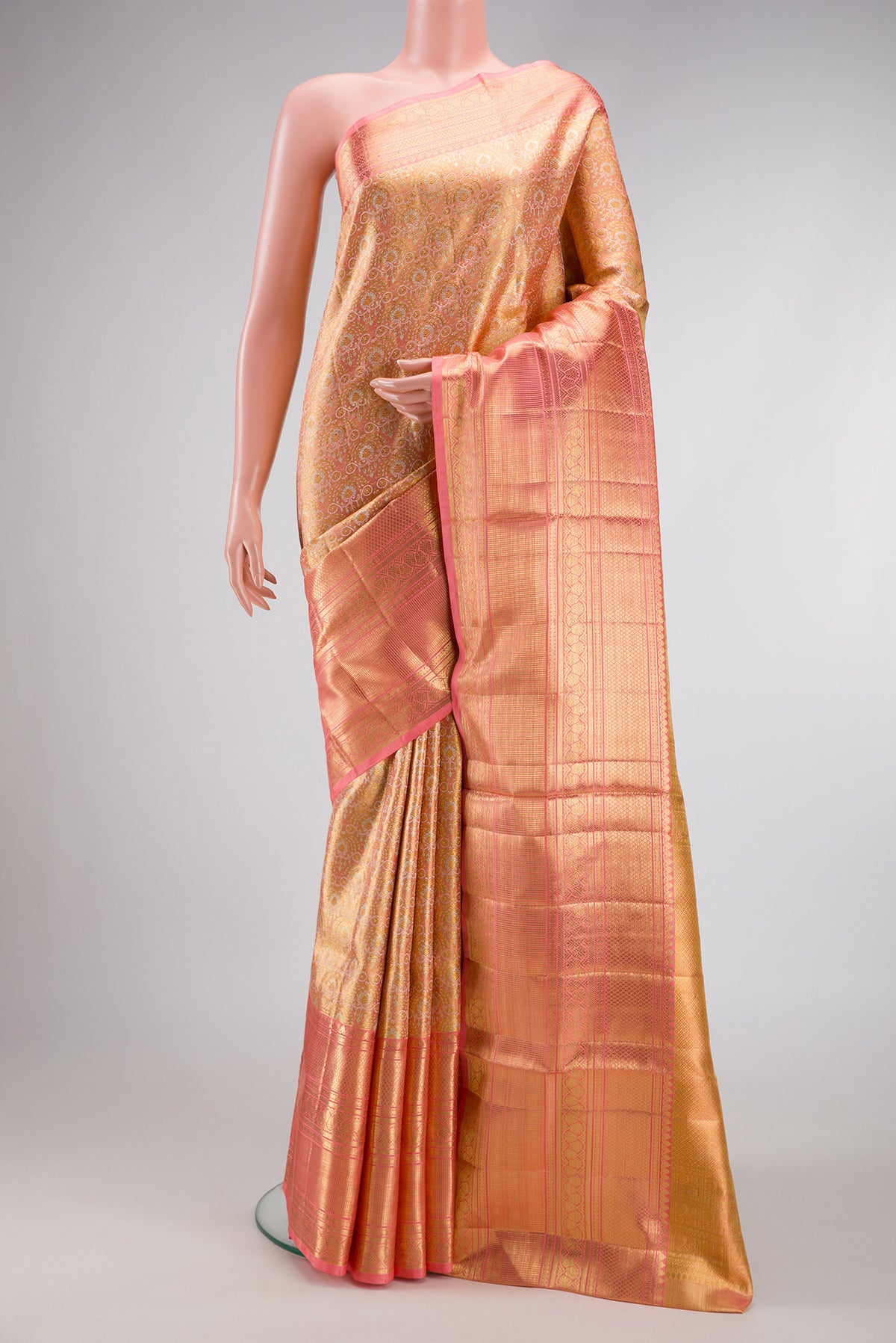 Peach Dual Tone Kanjivaram Tissue Silk Saree with Zari Brocade on the body and Zari Border.  displayed on a mannequin