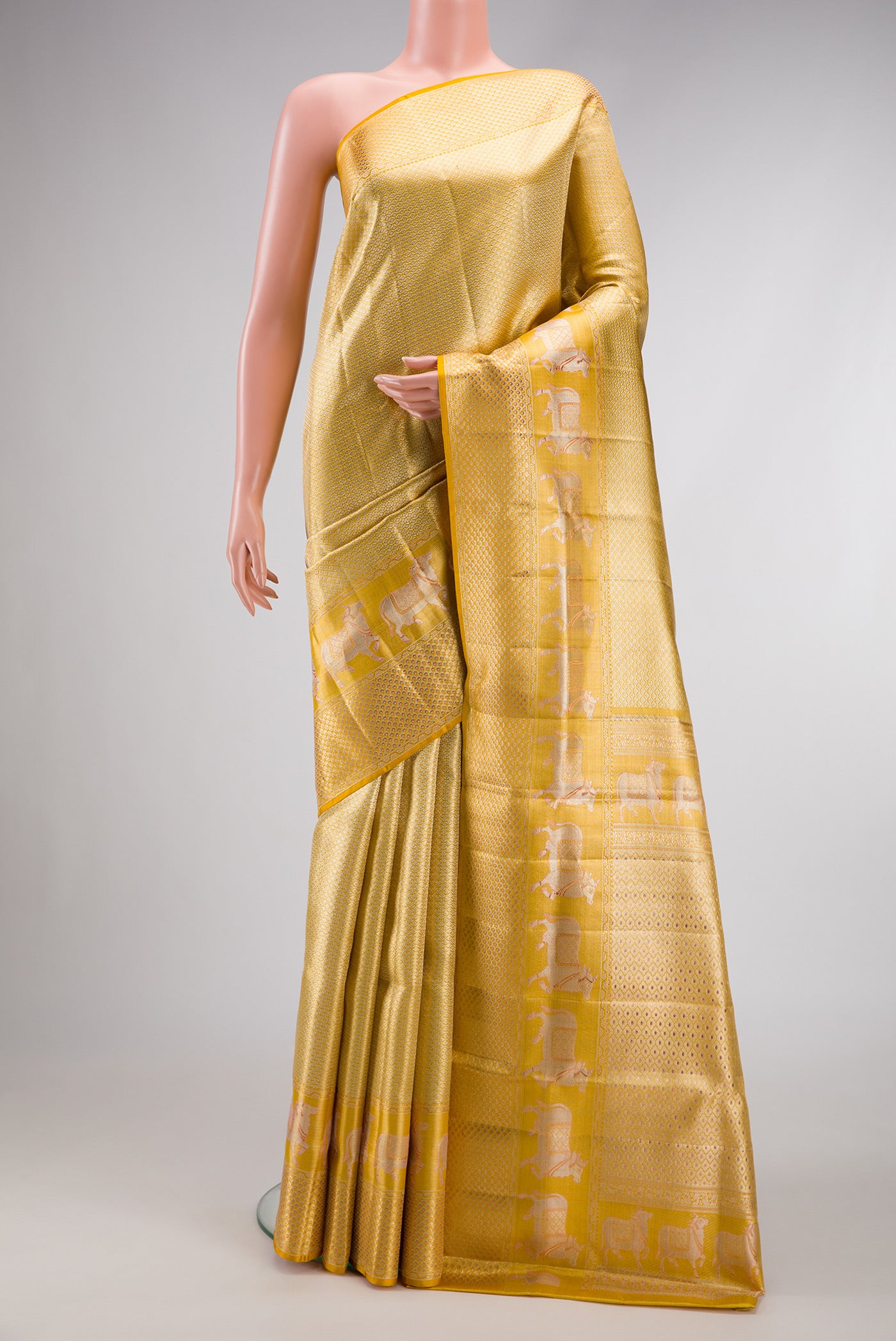 Pure Silk Pure Zari Yellow Dual Tone Kanjivaram Tissue Saree with Zari Brocade on the body and Fancy Border.  displayed on a mannequin