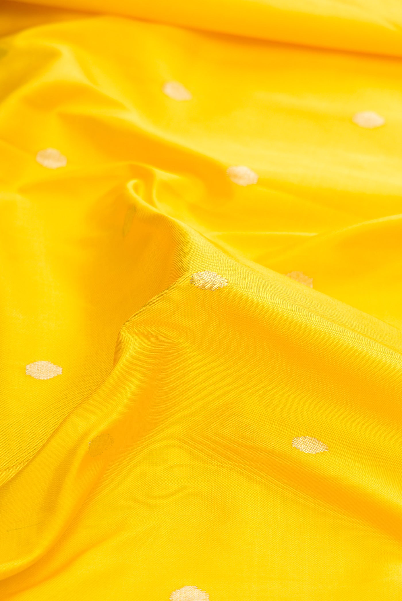 Close up of Pure Silk Pure Zari Yellow Dual Tone Paithani Saree with Zari Butta on the body and Paithani Border.  displaying folds