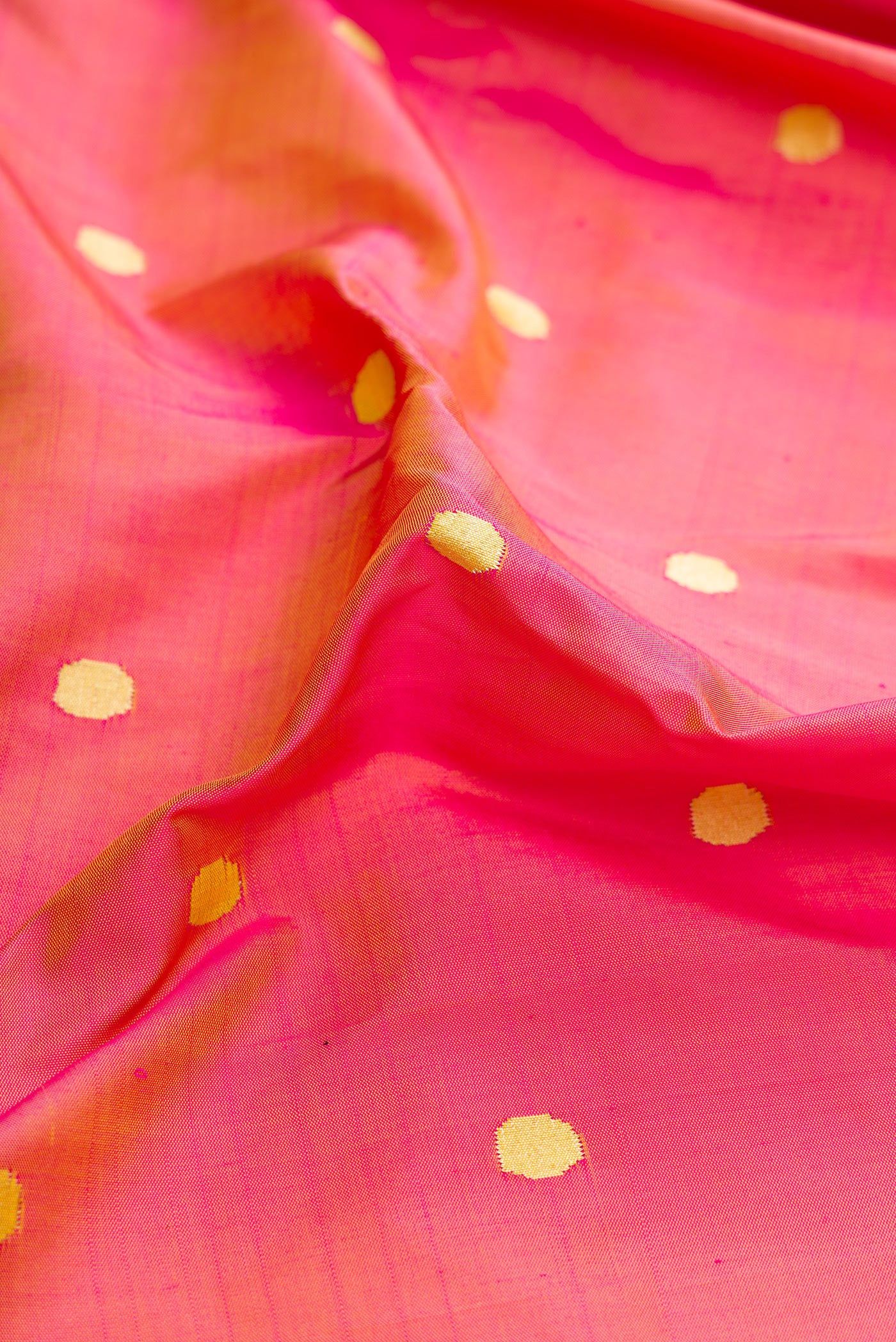 Close up of Pure Silk Pure Zari Pink Dual Tone Paithani Saree with Zari Butta on the body and Paithani Border.  displaying folds
