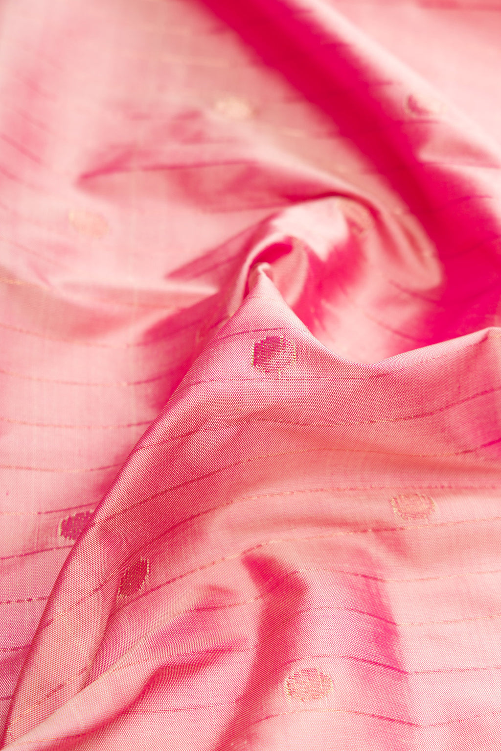 Close up of Pure Silk Pure Zari Rose Gold Dual Tone Paithani Saree with Stripes on the body and Paithani Border.  displaying folds