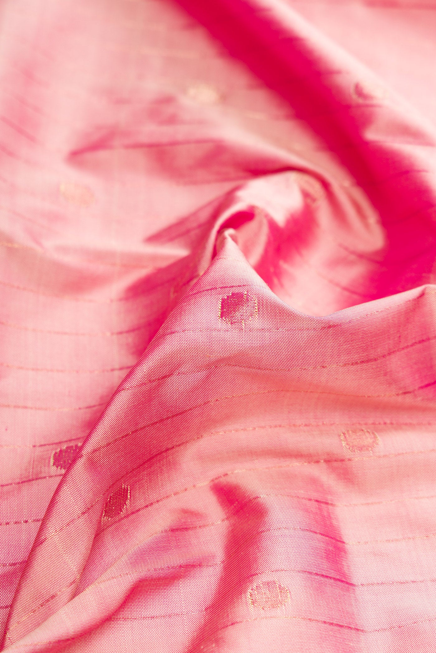 Close up of Pure Silk Pure Zari Rose Gold Dual Tone Paithani Saree with Stripes on the body and Paithani Border.  displaying folds