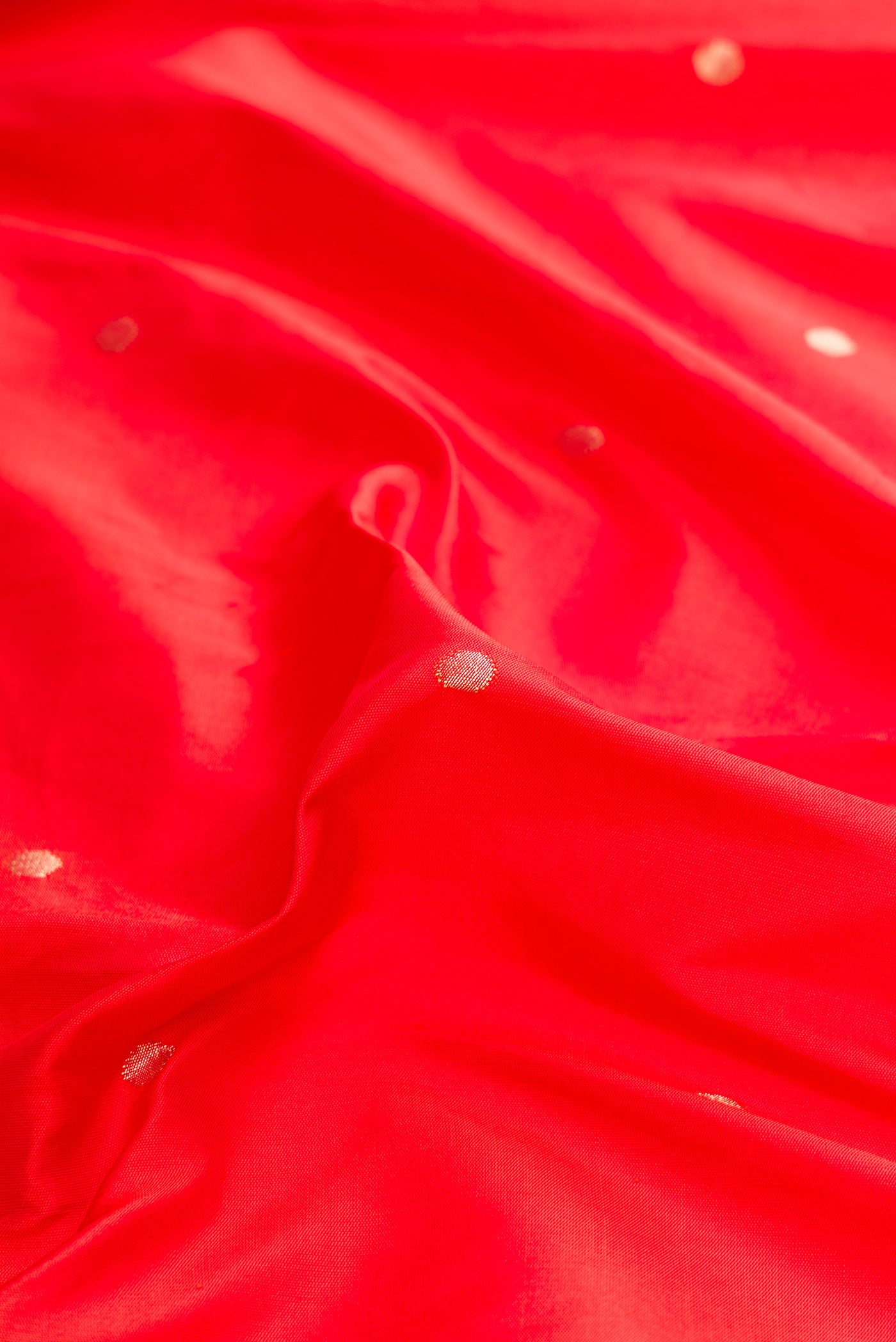 Close up of Pure Silk Pure Zari Red Dual Tone Paithani Saree with Zari Butta on the body and Paithani Border.  displaying folds