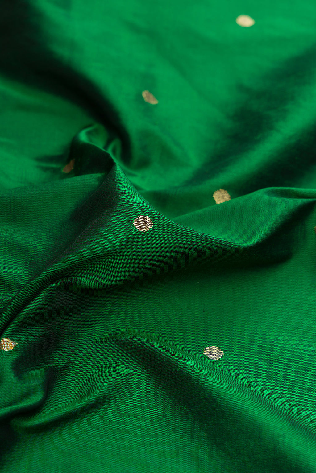 Close up of Pure Silk Pure Zari Bottle Green Dual Tone Paithani Saree with Zari Butta on the body and Paithani Border.  displaying folds