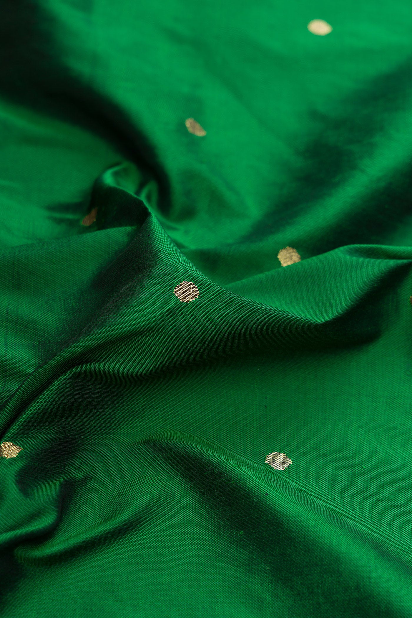 Close up of Pure Silk Pure Zari Bottle Green Dual Tone Paithani Saree with Zari Butta on the body and Paithani Border.  displaying folds