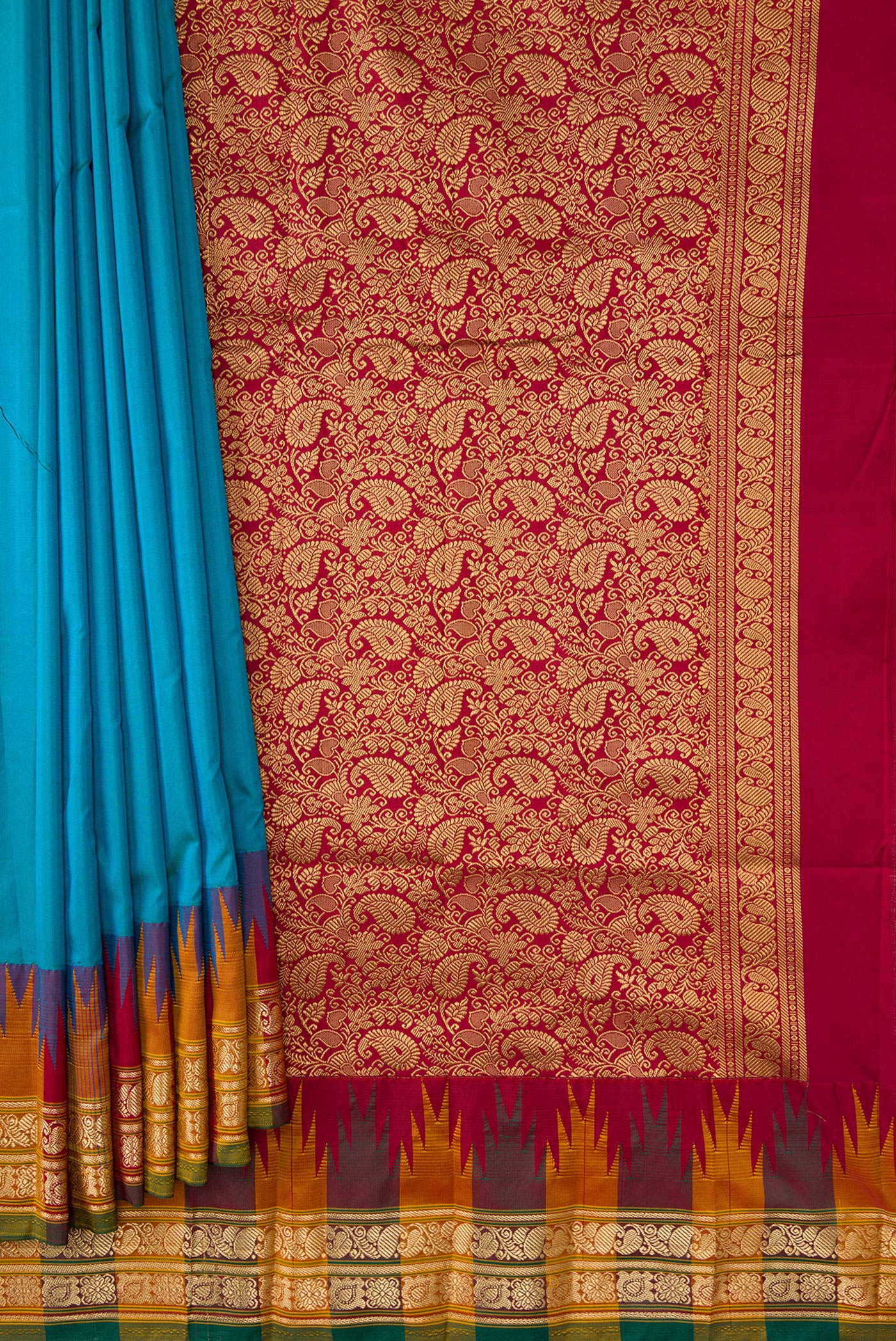 Pleats and pallu of Peacock Blue Dual Tone Kanjivaram Silk Saree with Zari Butta on the body and Temple Border. 