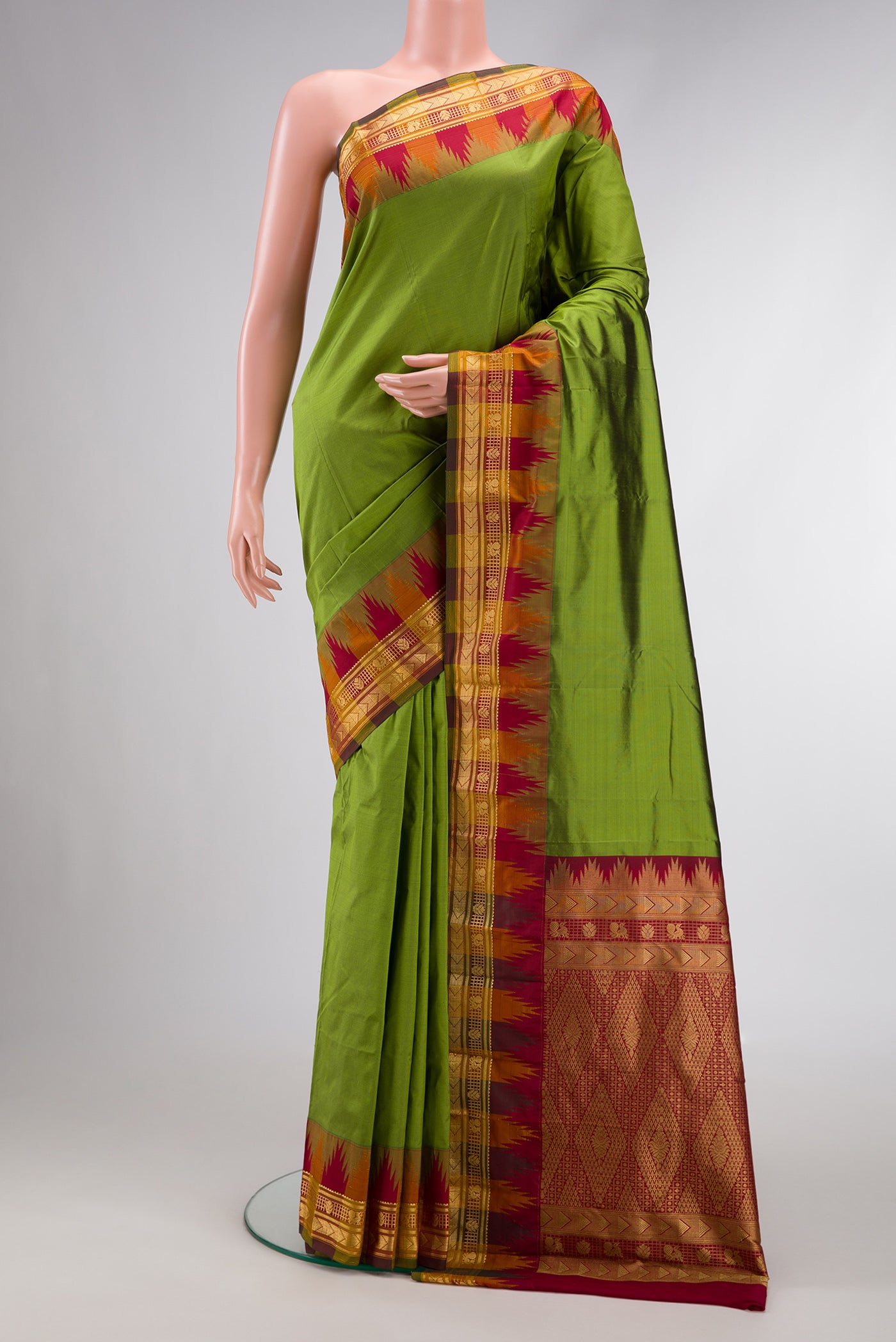 Pista Green Dual Tone Kanjivaram Silk Saree with Zari Butta on the body and Temple Border.  displayed on a mannequin