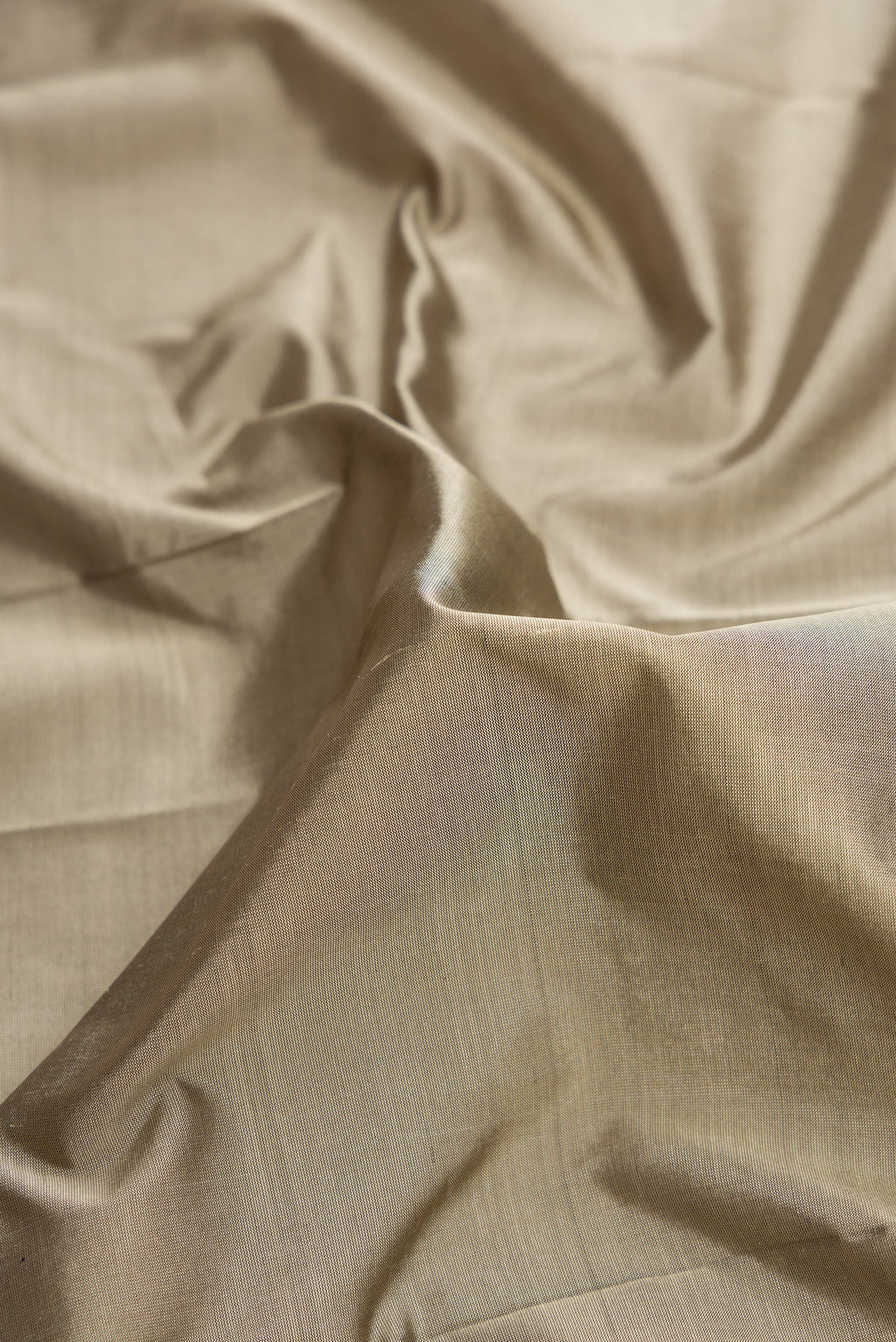 Close up of Grey Dual Tone Kanjivaram Silk Saree with Plain Body and Temple Border.  displaying folds