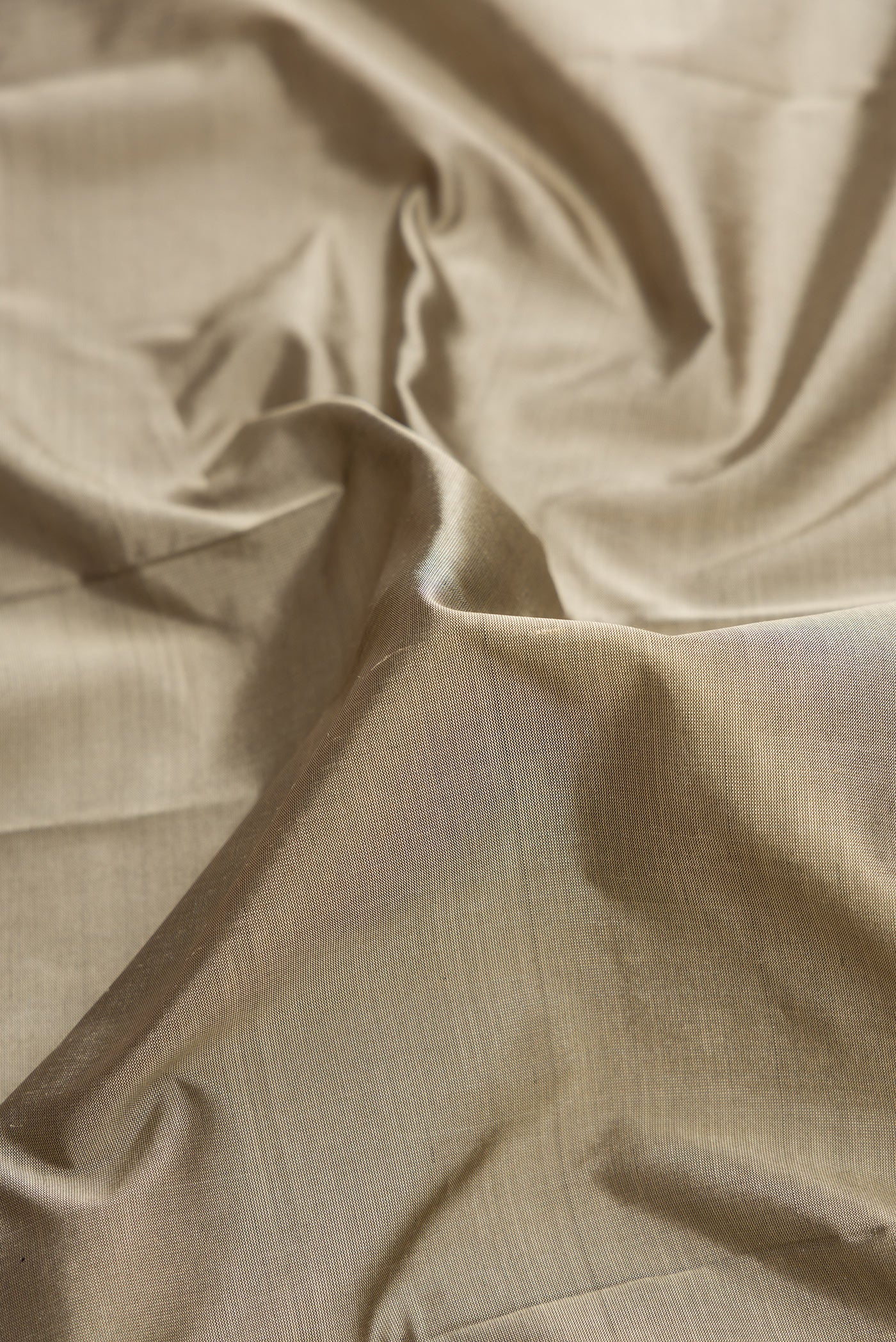 Close up of Grey Dual Tone Kanjivaram Silk Saree with Plain Body and Temple Border.  displaying folds