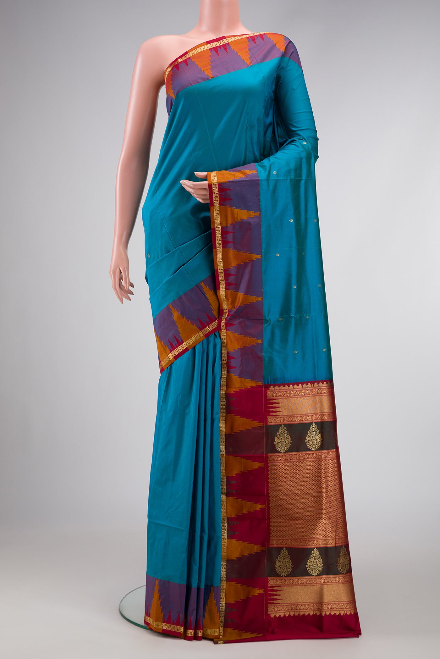 Peacock Blue Dual Tone Kanchipuram Silk Saree with Plain Body and Temple Border.  displayed on a mannequin
