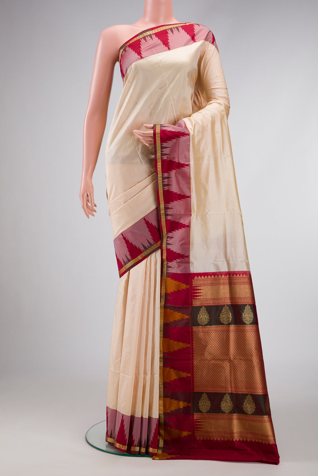 Off White Dual Tone Kanchipuram Silk Saree with Zari Butta on the body and Temple Border.  displayed on a mannequin