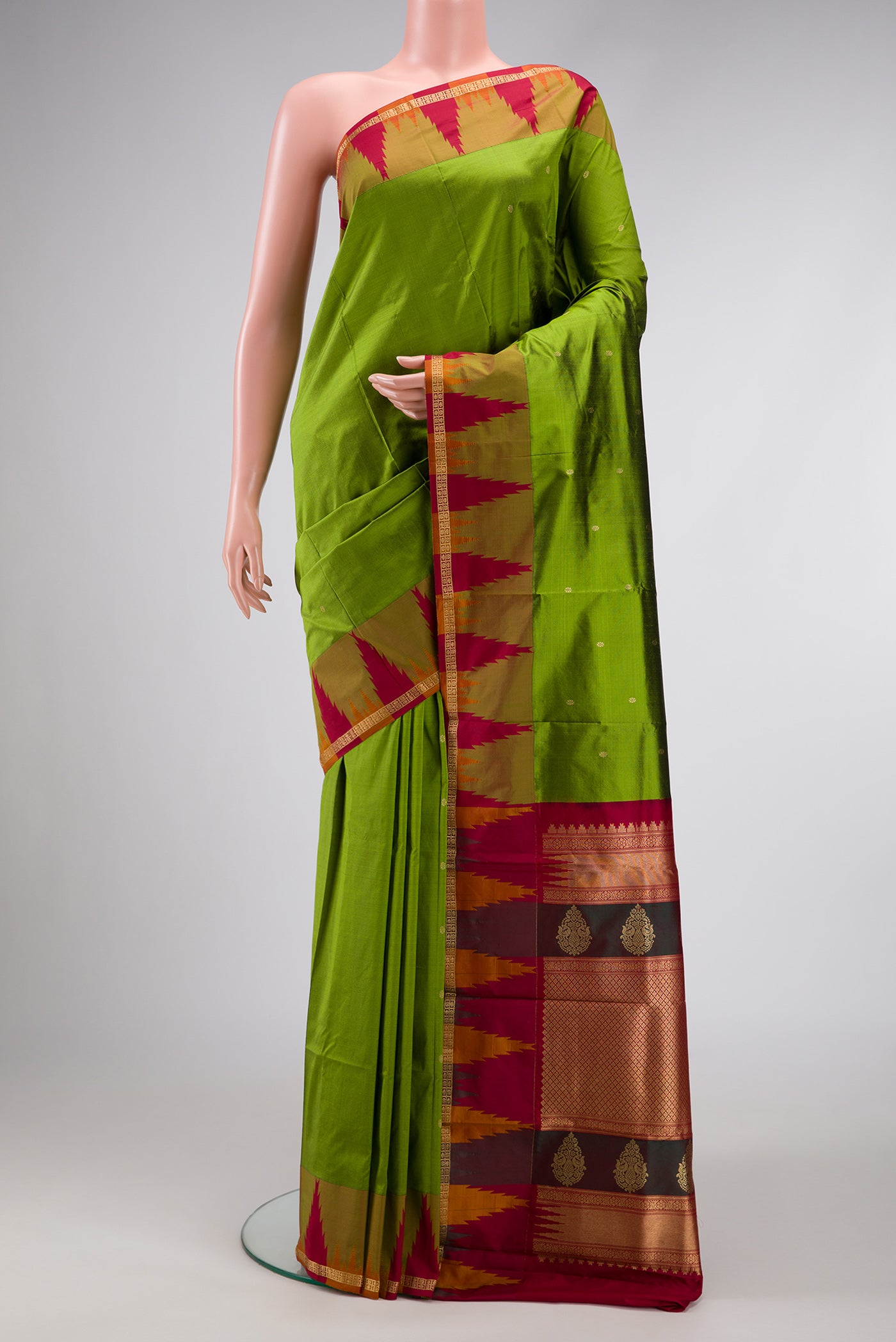 Green Dual Tone Kanchipuram Silk Saree with Zari Butta on the body and Temple Border.  displayed on a mannequin