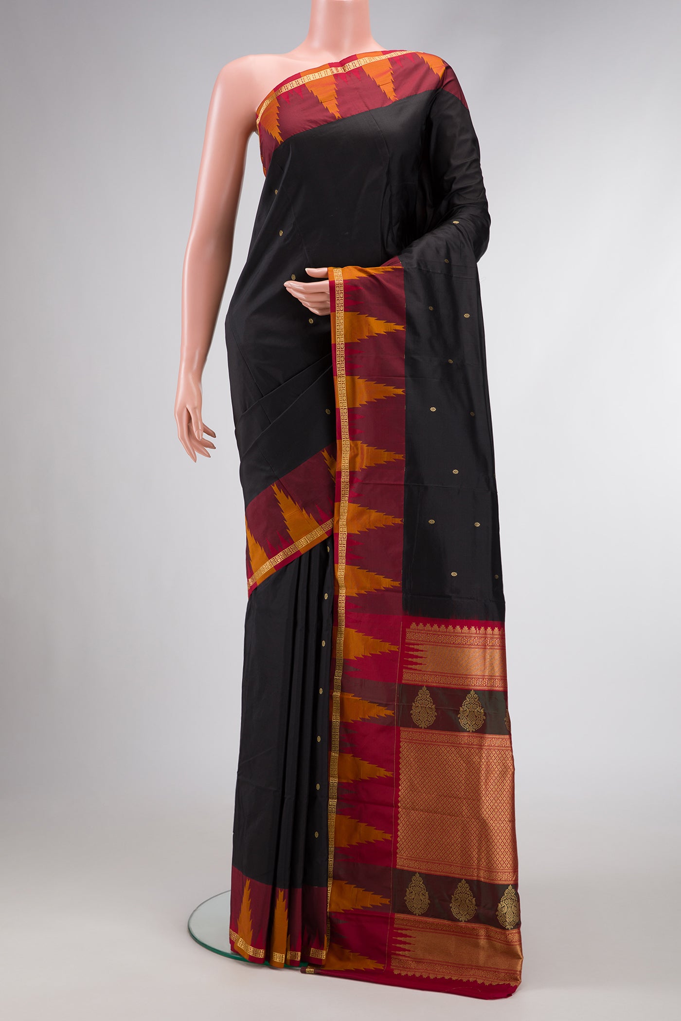 Black Dual Tone Kanchipuram Silk Saree with Zari Butta on the body and Temple Border.  displayed on a mannequin