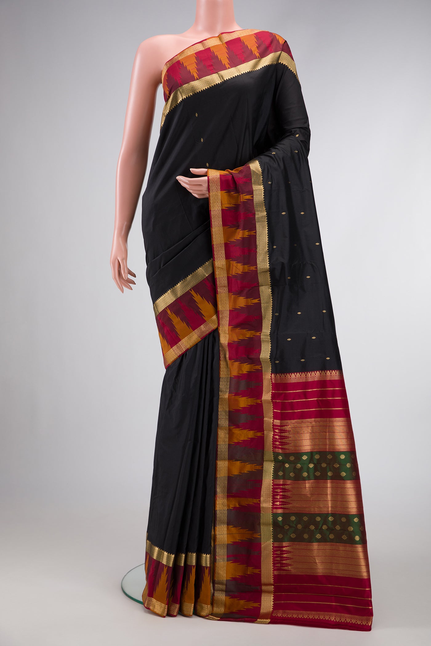 Black Dual Tone Kanchipuram Silk Saree with Zari Butta on the body and Zari Border.  displayed on a mannequin